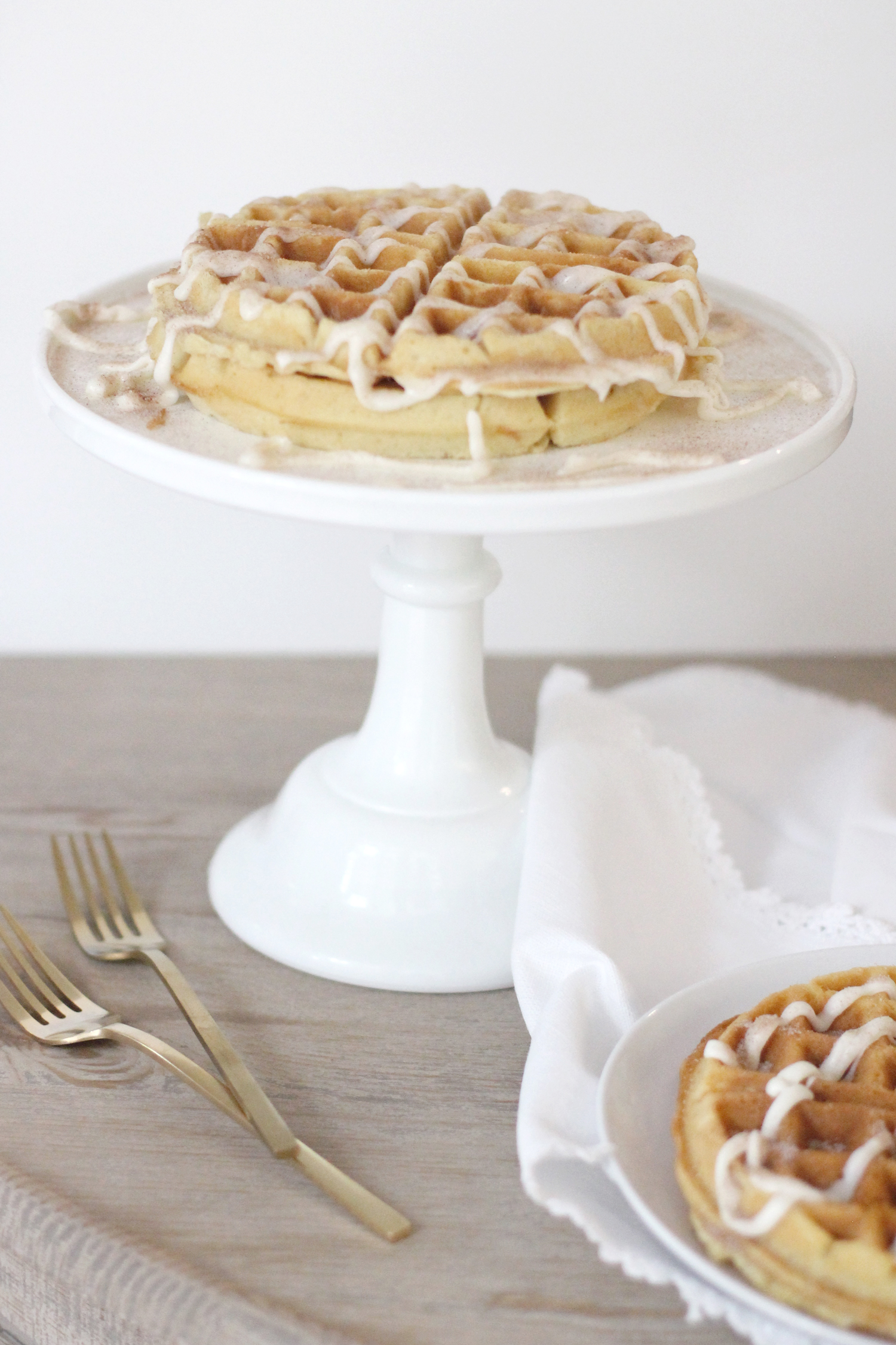 Cinnamon-Roll-Waffles-made-using-simple-cake-mix-and-vanilla-frosting-drizzle---glitterinc.com