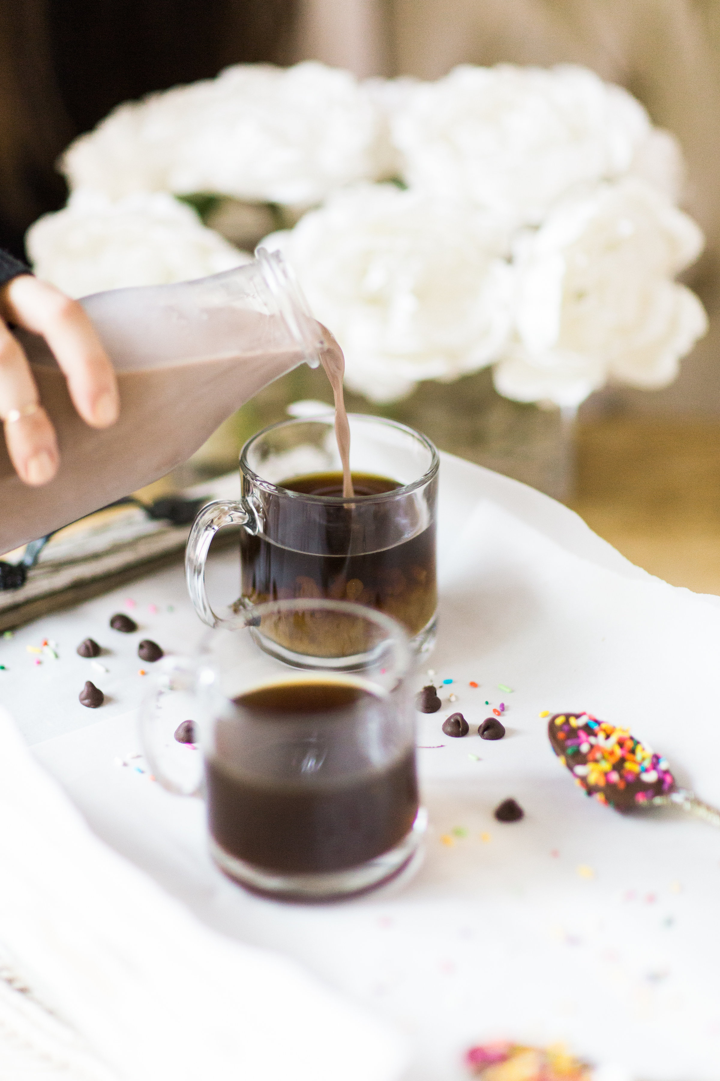 How to make an almond milk chocolate glazed donut coffee with chocolate-dipped sprinkle spoons. Click through for the details. | glitterinc.com | @glitterinc