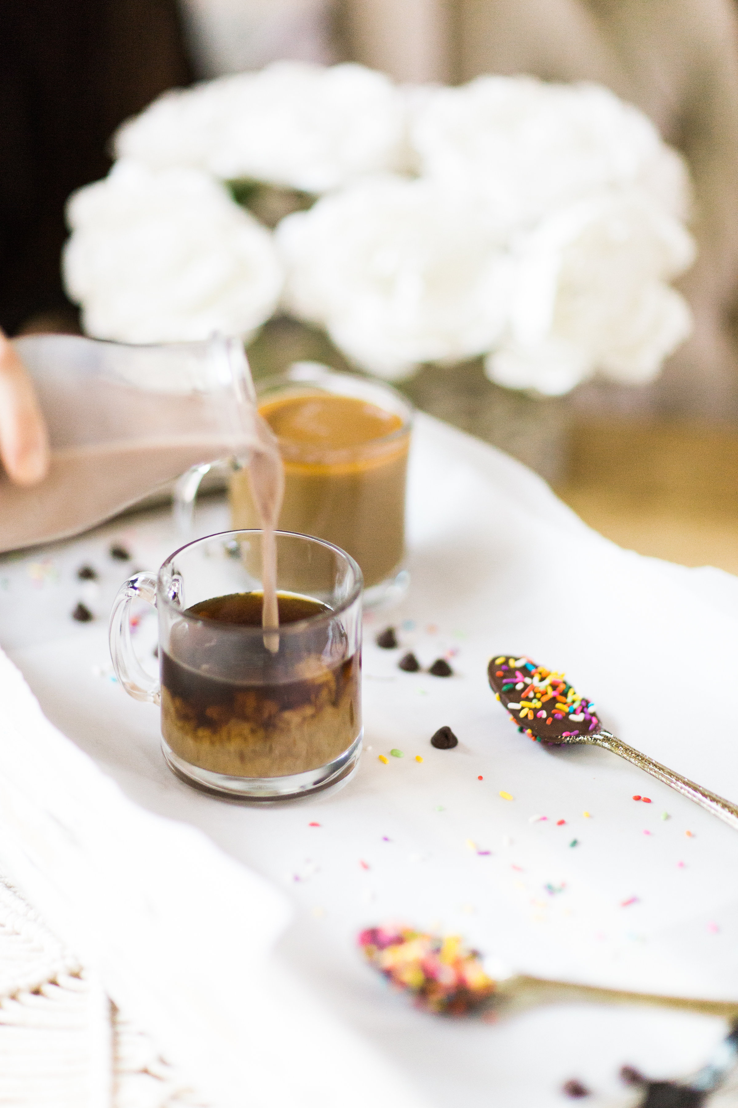 How to make an almond milk chocolate glazed donut coffee with chocolate-dipped sprinkle spoons. Click through for the details. | glitterinc.com | @glitterinc