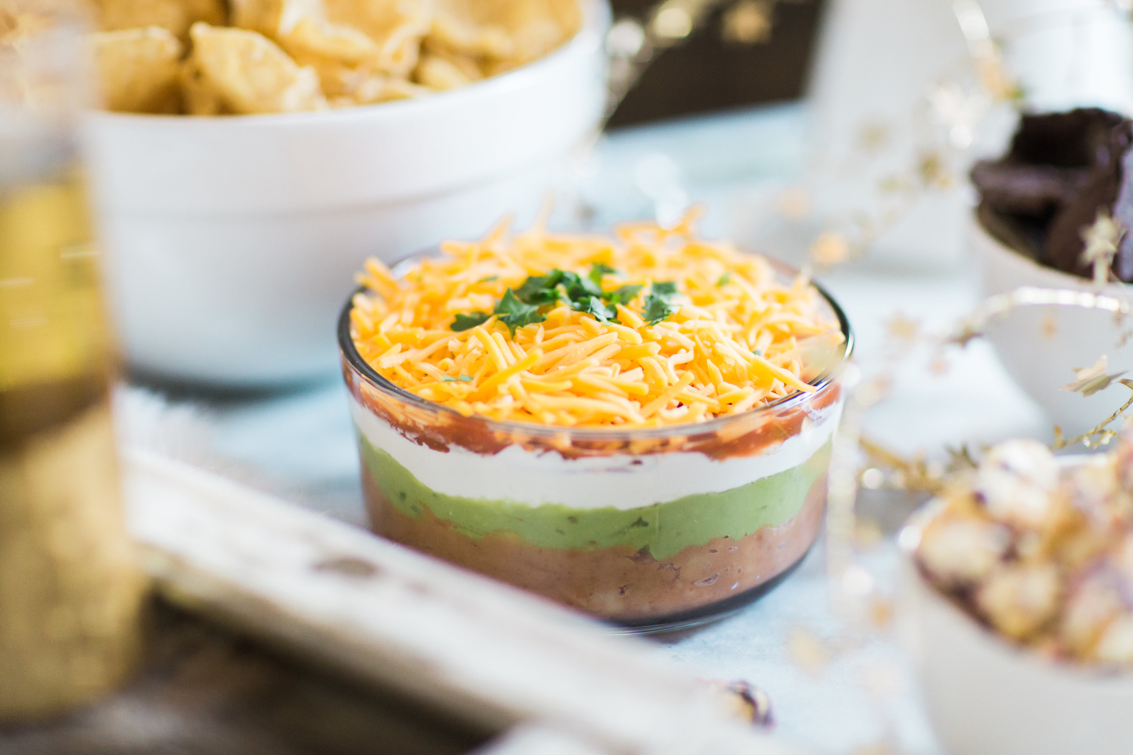 How to make easy 7-layer dip. Click through for the recipe. | glitterinc.com | @glitterinc