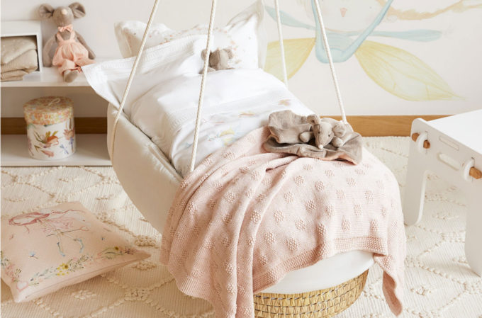 hanging bed with pillows and stuffed toys