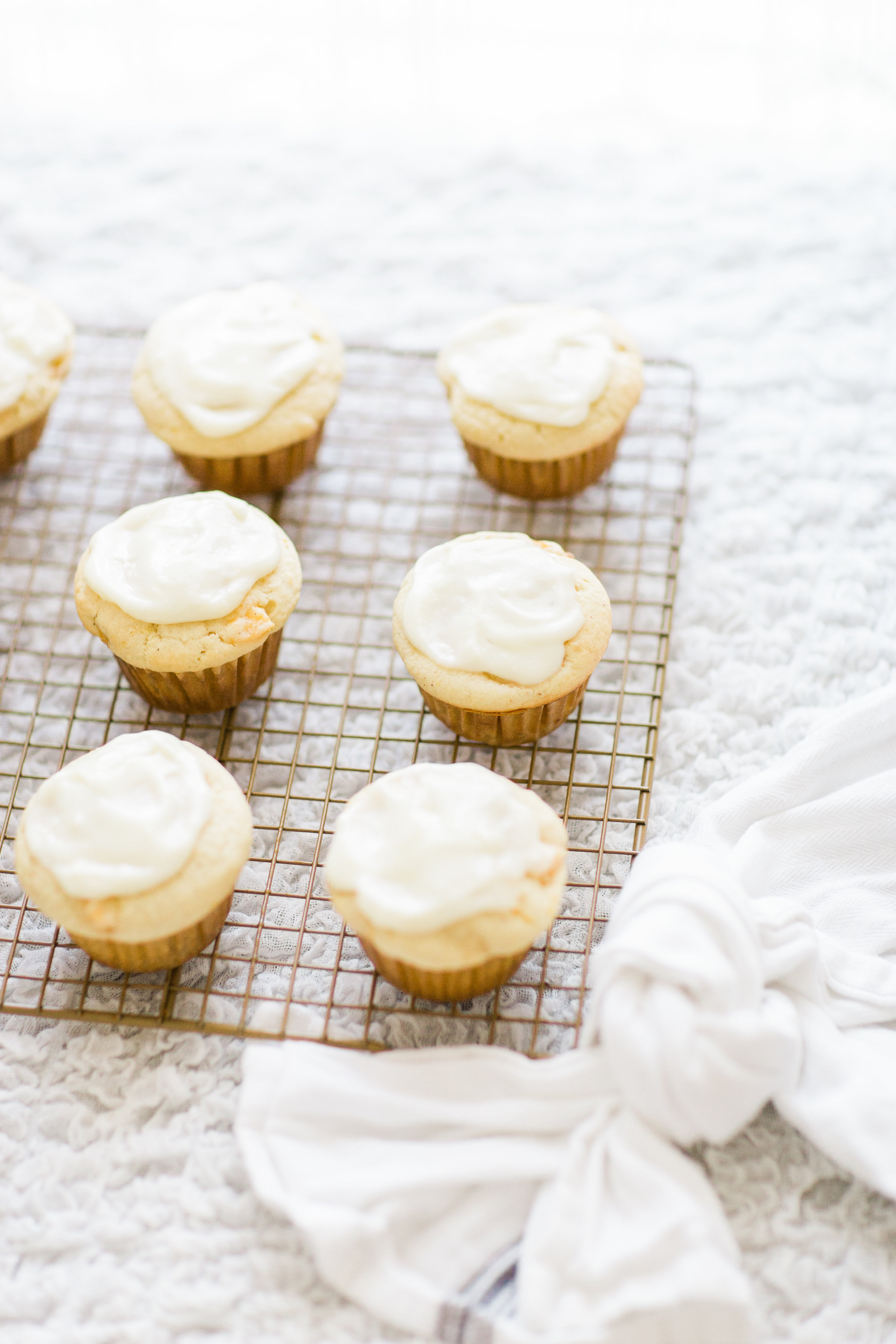 Lifestyle blogger Lexi of Glitter, Inc. shares her recipe for heavenly peaches and cream muffins with decadent cream cheese frosting. | glitterinc.com | @glitterinc