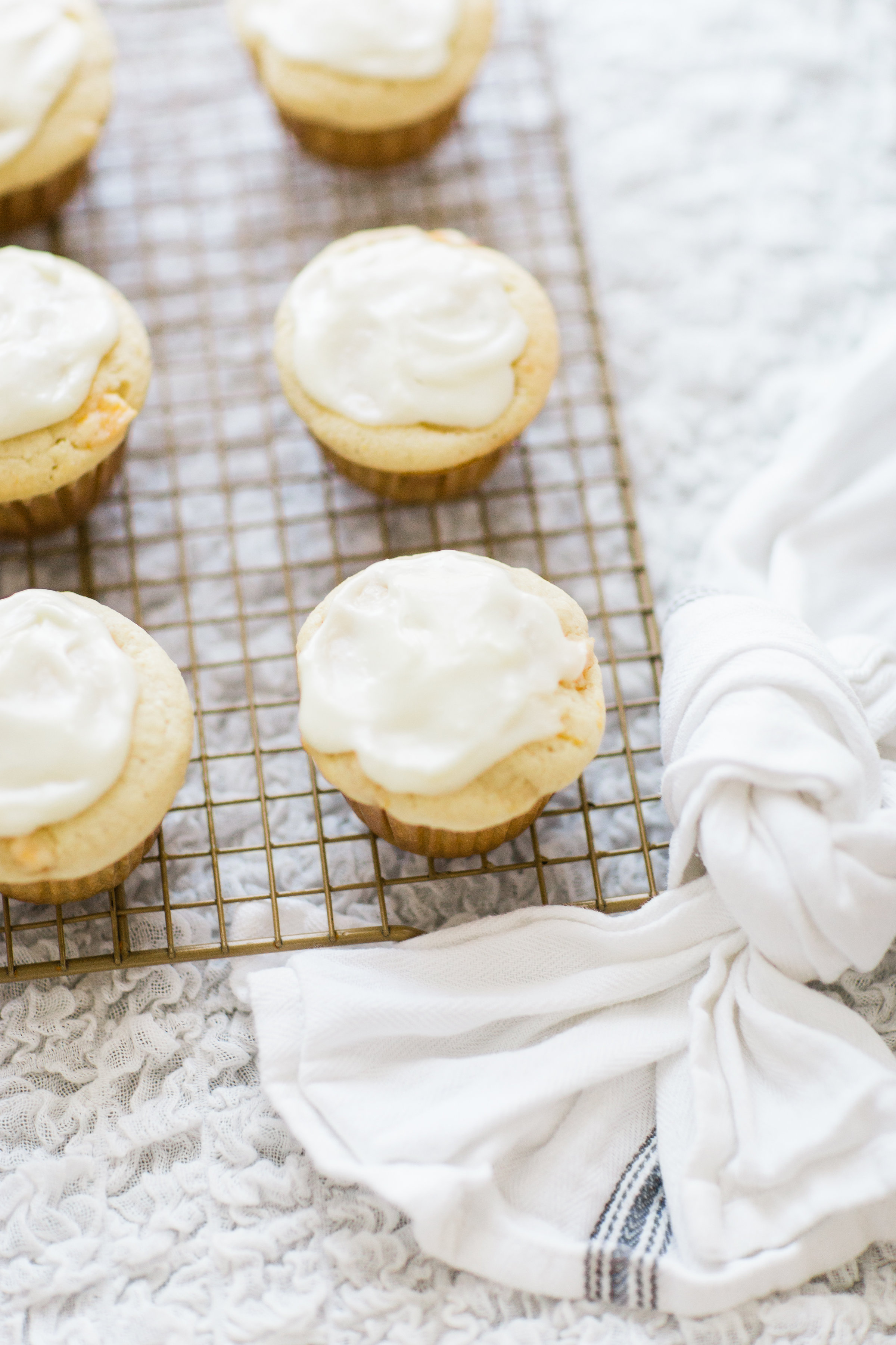 Lifestyle blogger Lexi of Glitter, Inc. shares her recipe for heavenly peaches and cream muffins with decadent cream cheese frosting. | glitterinc.com | @glitterinc