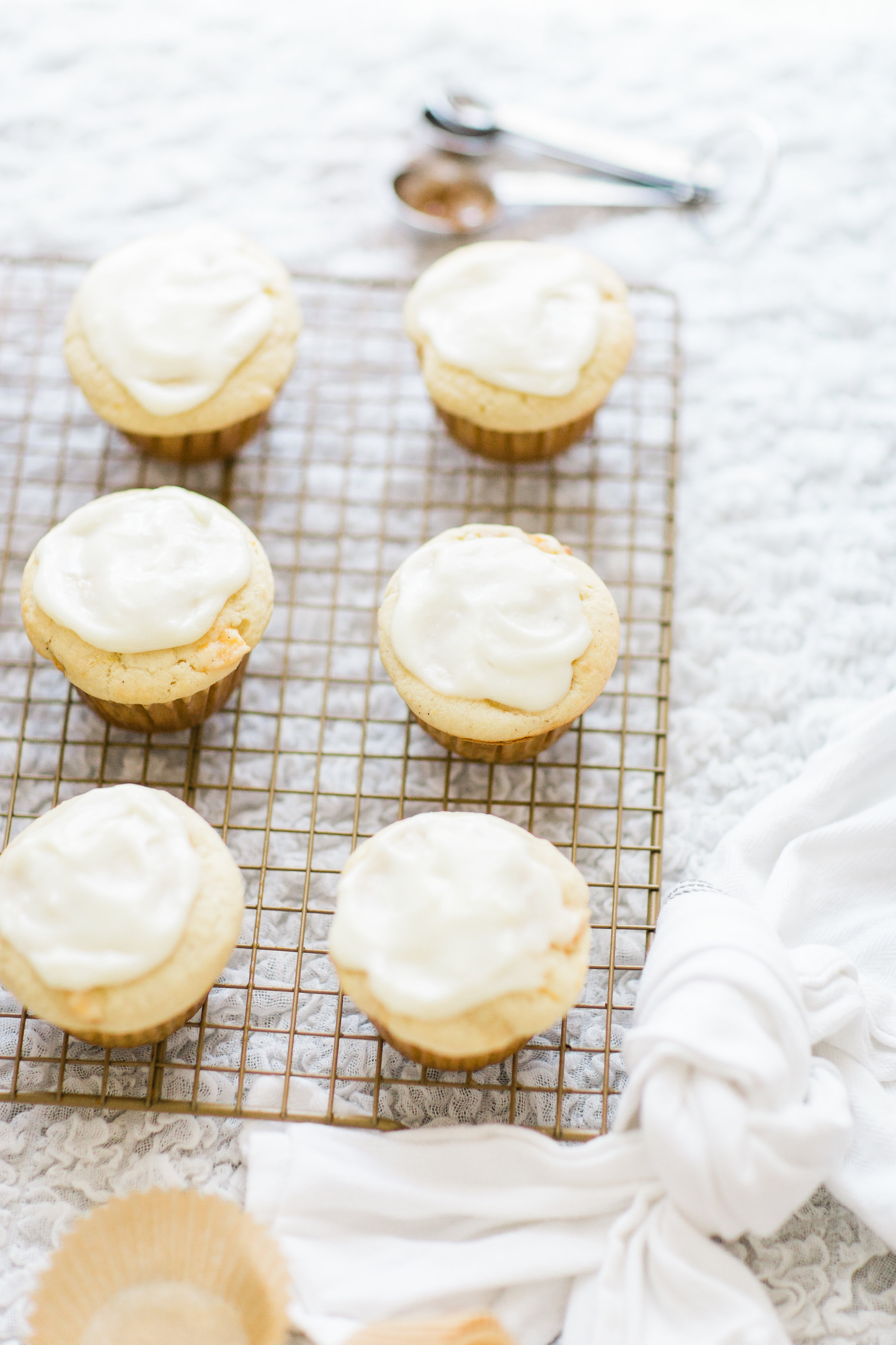 Lifestyle blogger Lexi of Glitter, Inc. shares her recipe for heavenly peaches and cream muffins with decadent cream cheese frosting. | glitterinc.com | @glitterinc