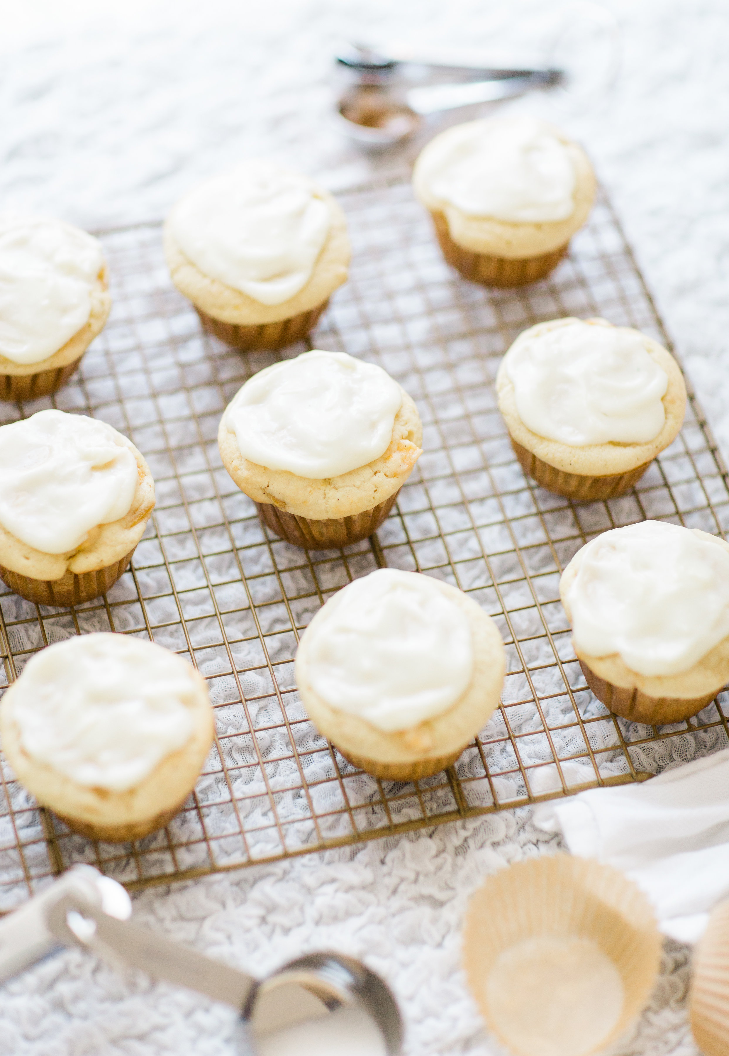 Lifestyle blogger Lexi of Glitter, Inc. shares her recipe for heavenly peaches and cream muffins with decadent cream cheese frosting. | glitterinc.com | @glitterinc