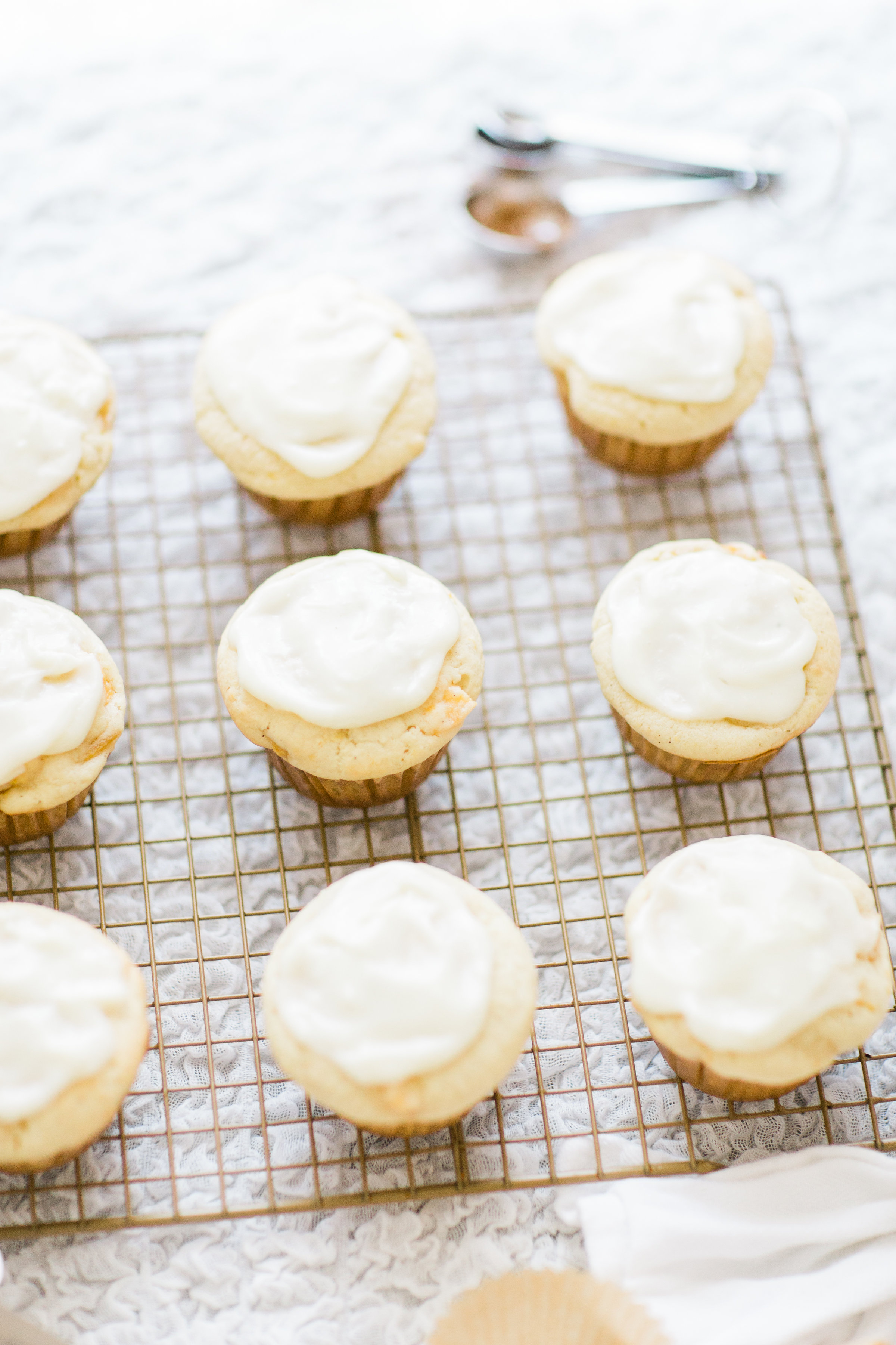 Lifestyle blogger Lexi of Glitter, Inc. shares her recipe for heavenly peaches and cream muffins with decadent cream cheese frosting. | glitterinc.com | @glitterinc