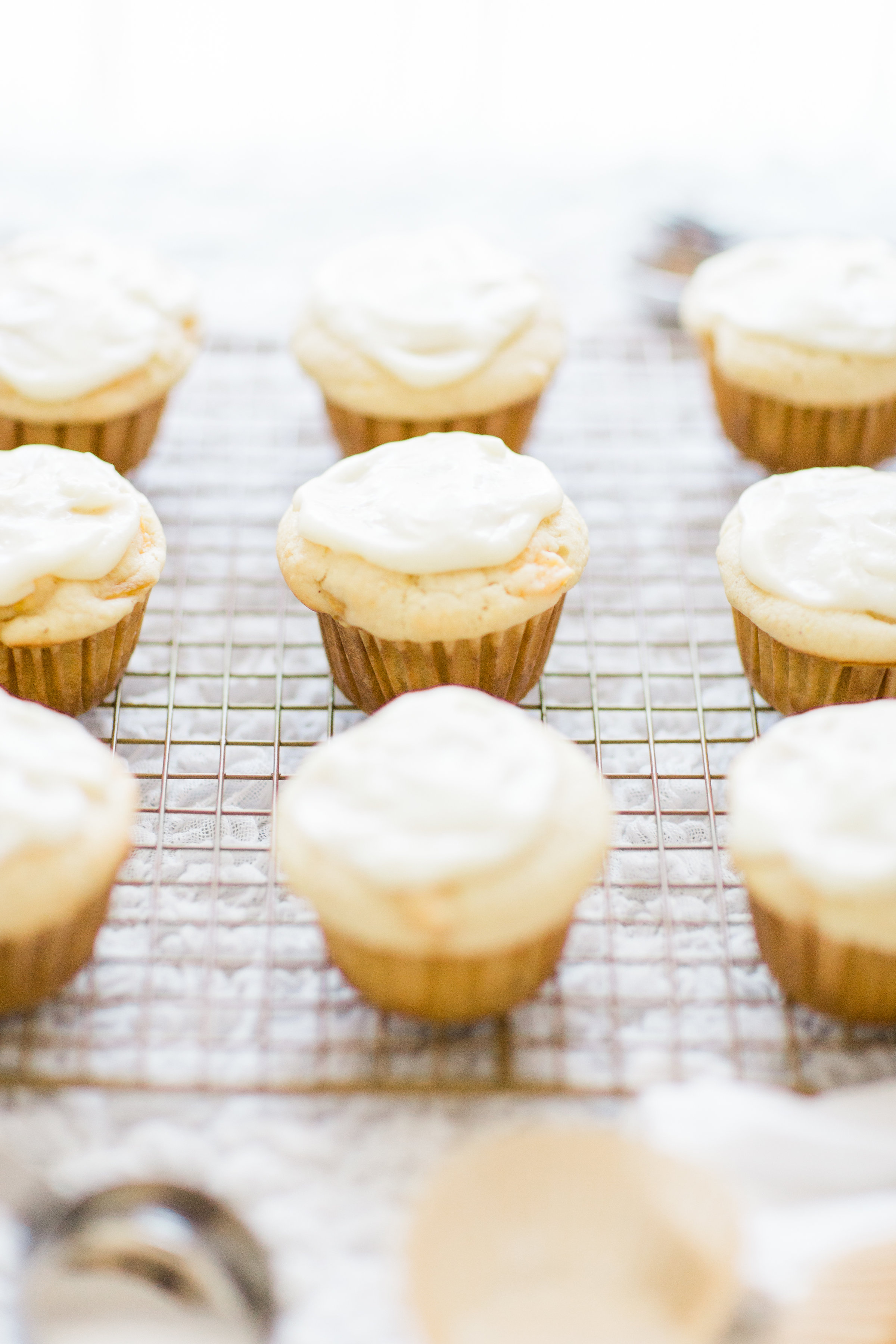 Lifestyle blogger Lexi of Glitter, Inc. shares her recipe for heavenly peaches and cream muffins with decadent cream cheese frosting. | glitterinc.com | @glitterinc