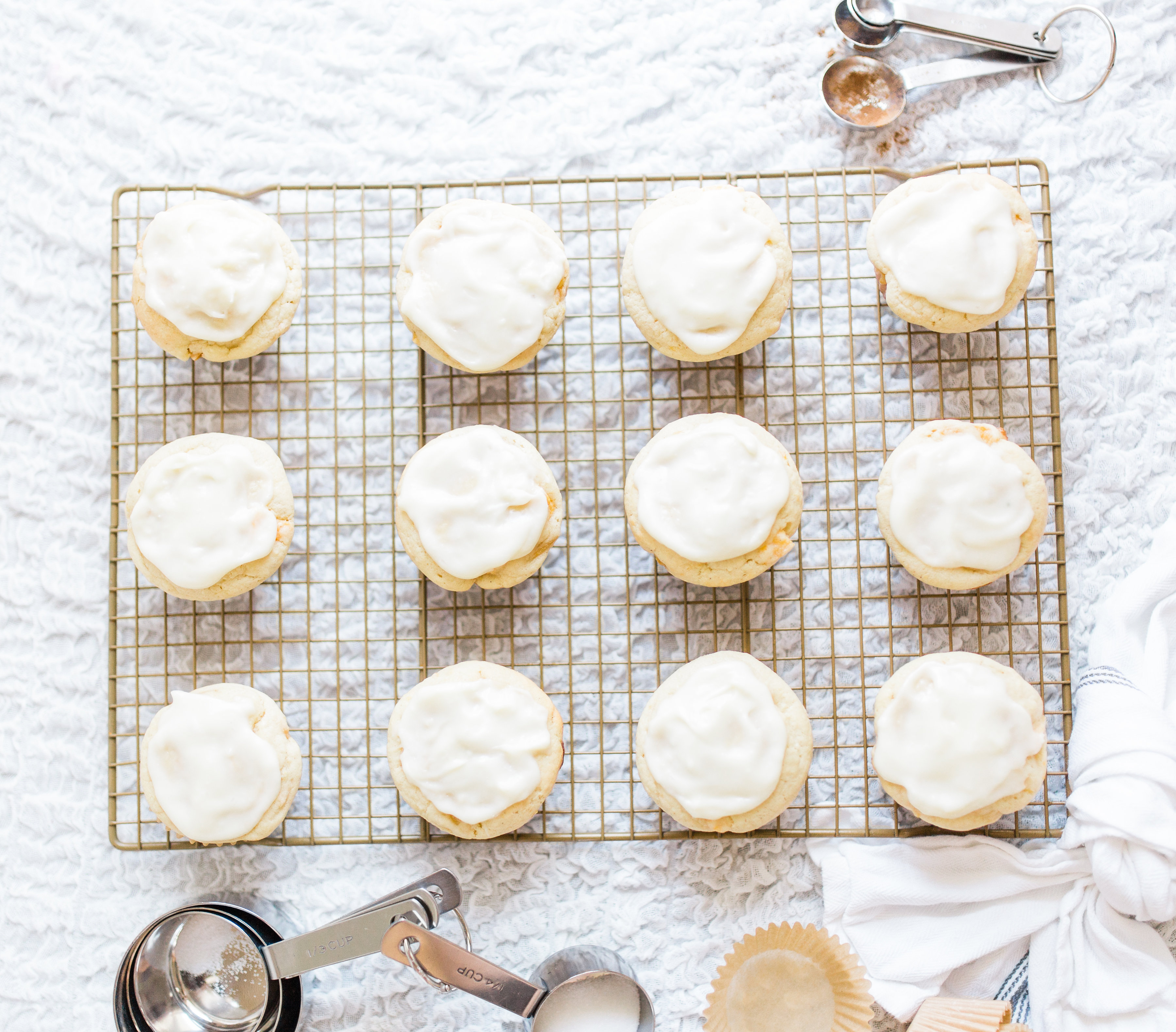 Lifestyle blogger Lexi of Glitter, Inc. shares her recipe for heavenly peaches and cream muffins with decadent cream cheese frosting. | glitterinc.com | @glitterinc