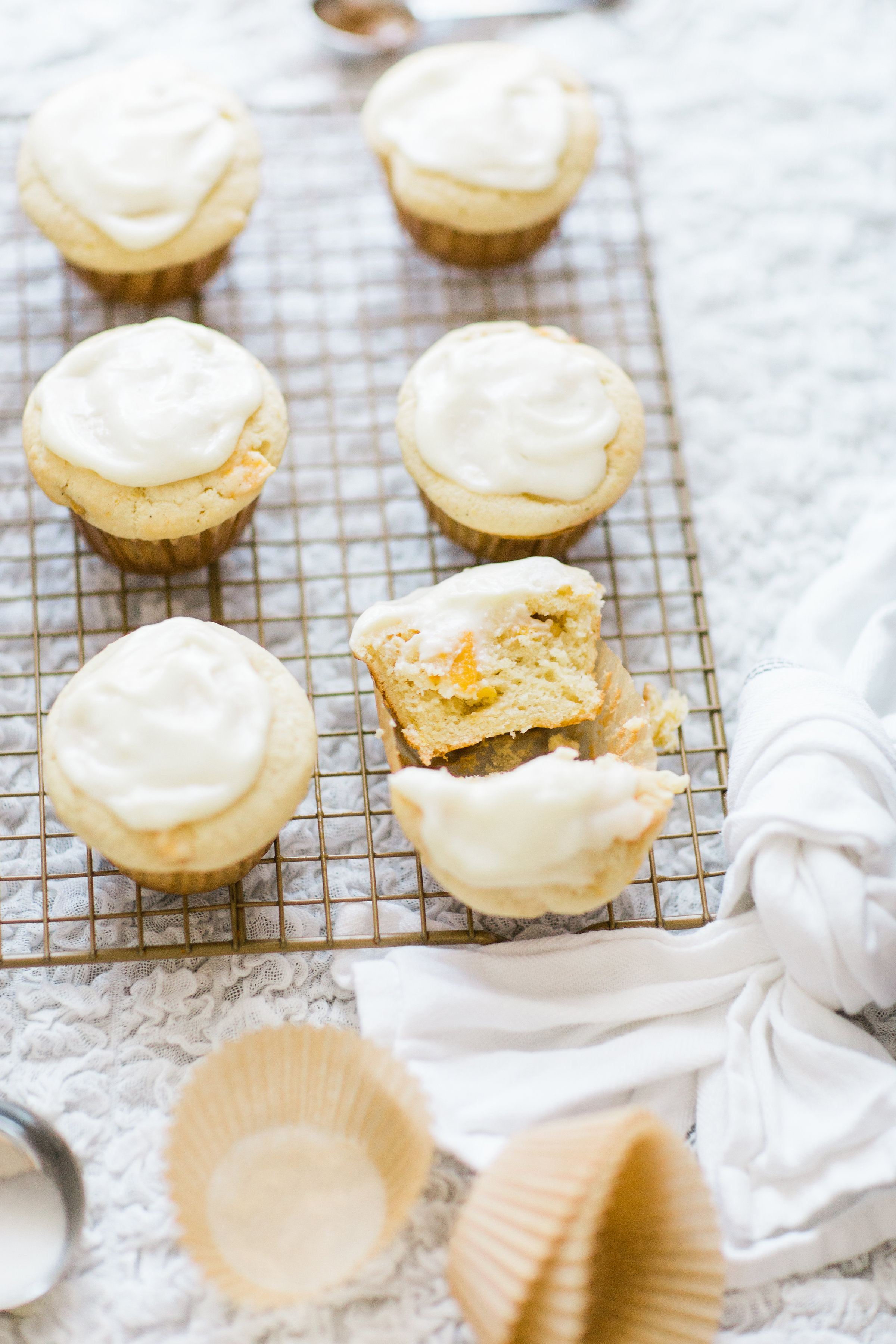 Lifestyle blogger Lexi of Glitter, Inc. shares her recipe for heavenly peaches and cream muffins with decadent cream cheese frosting. | glitterinc.com | @glitterinc