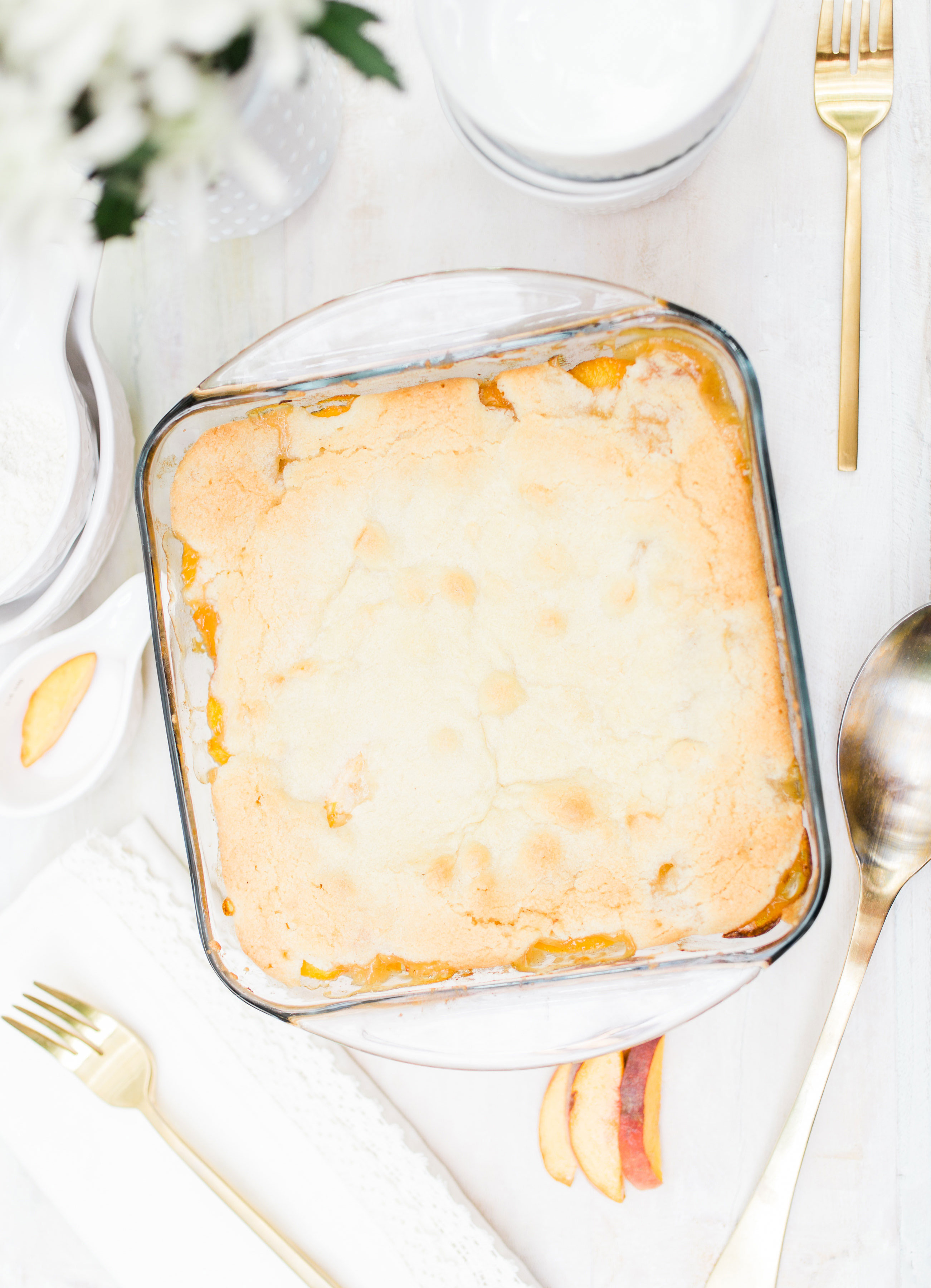 Foodie blogger Lexi of Glitter, Inc. shares a recipe for classic peach cobbler. Caramelized peaches are topped with a sugar-cookie-like doughy crust. YUM. | glitterinc.com | @glitterinc