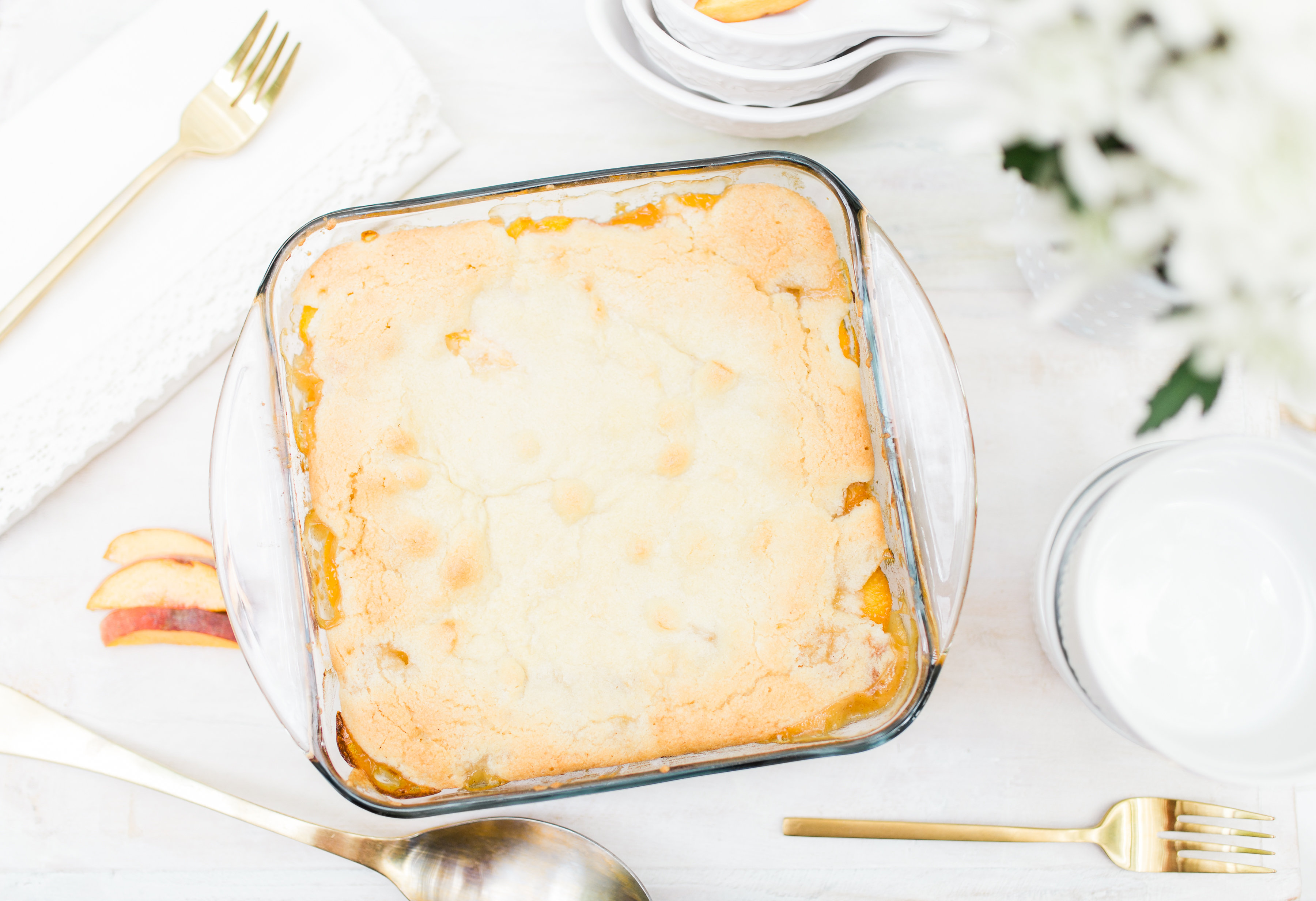 Foodie blogger Lexi of Glitter, Inc. shares a recipe for classic peach cobbler. Caramelized peaches are topped with a sugar-cookie-like doughy crust. YUM. | glitterinc.com | @glitterinc