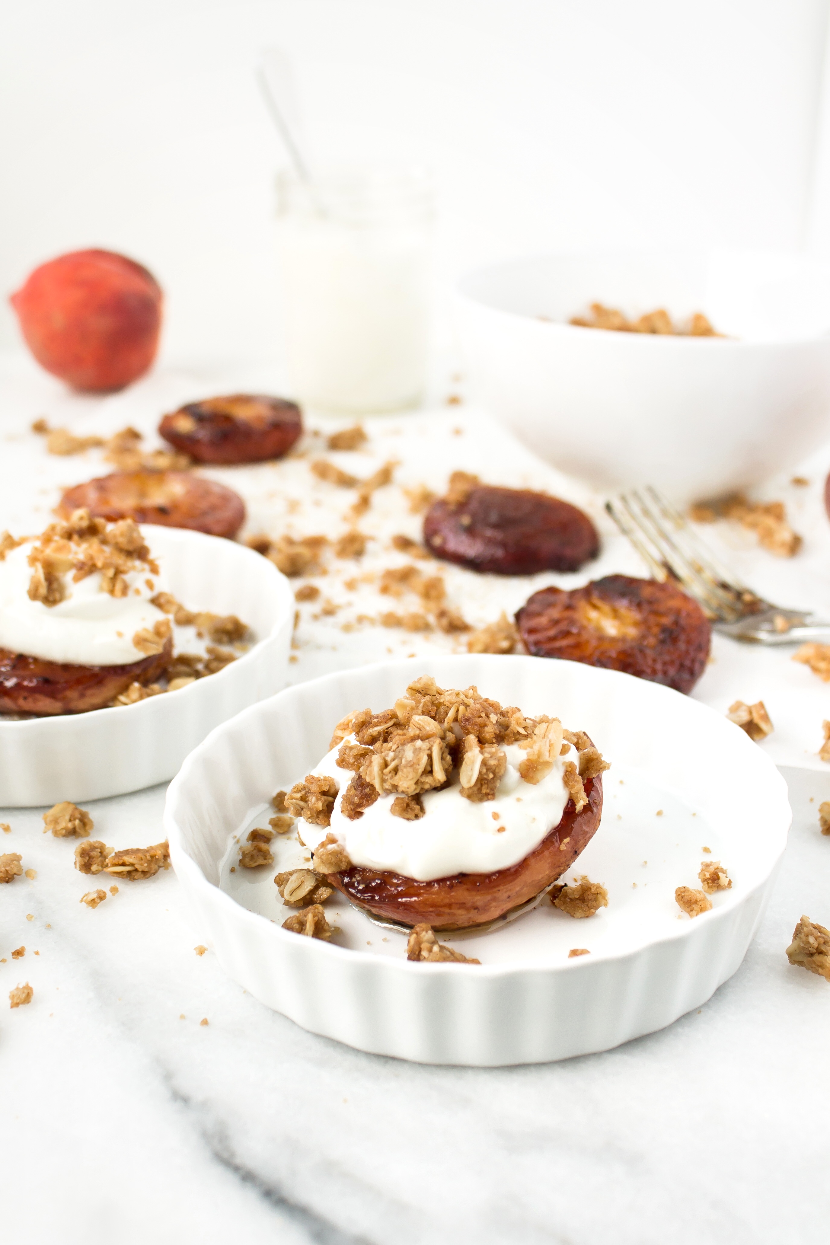 Foodie blogger Lexi of Glitter, Inc. shares the most incredible caramely roasted peaches with yogurt and homemade streusel. Click through for the recipe. | glitterinc.com | @glitterinc