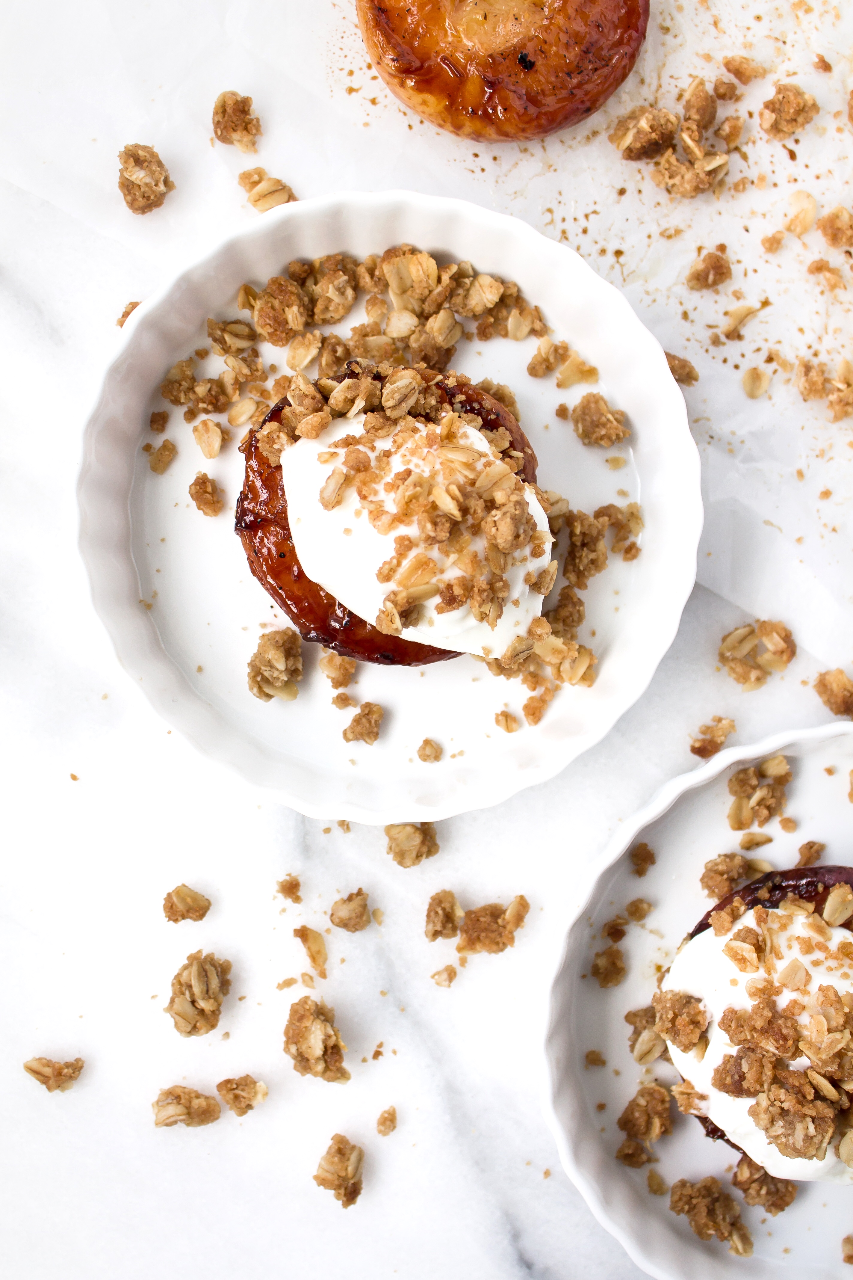 Foodie blogger Lexi of Glitter, Inc. shares the most incredible caramely roasted peaches with yogurt and homemade streusel. Click through for the recipe. | glitterinc.com | @glitterinc