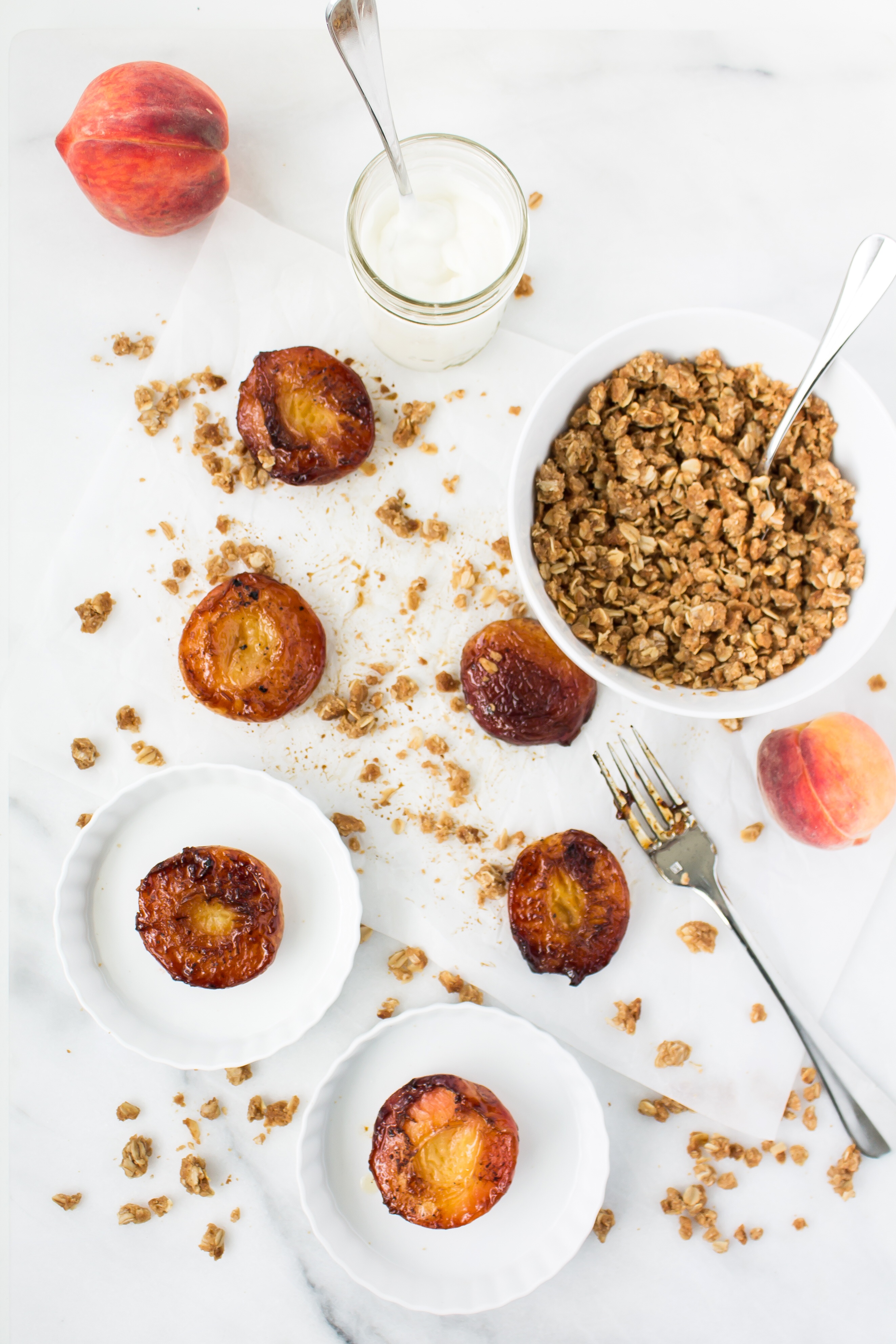 Foodie blogger Lexi of Glitter, Inc. shares the most incredible caramely roasted peaches with yogurt and homemade streusel. Click through for the recipe. | glitterinc.com | @glitterinc