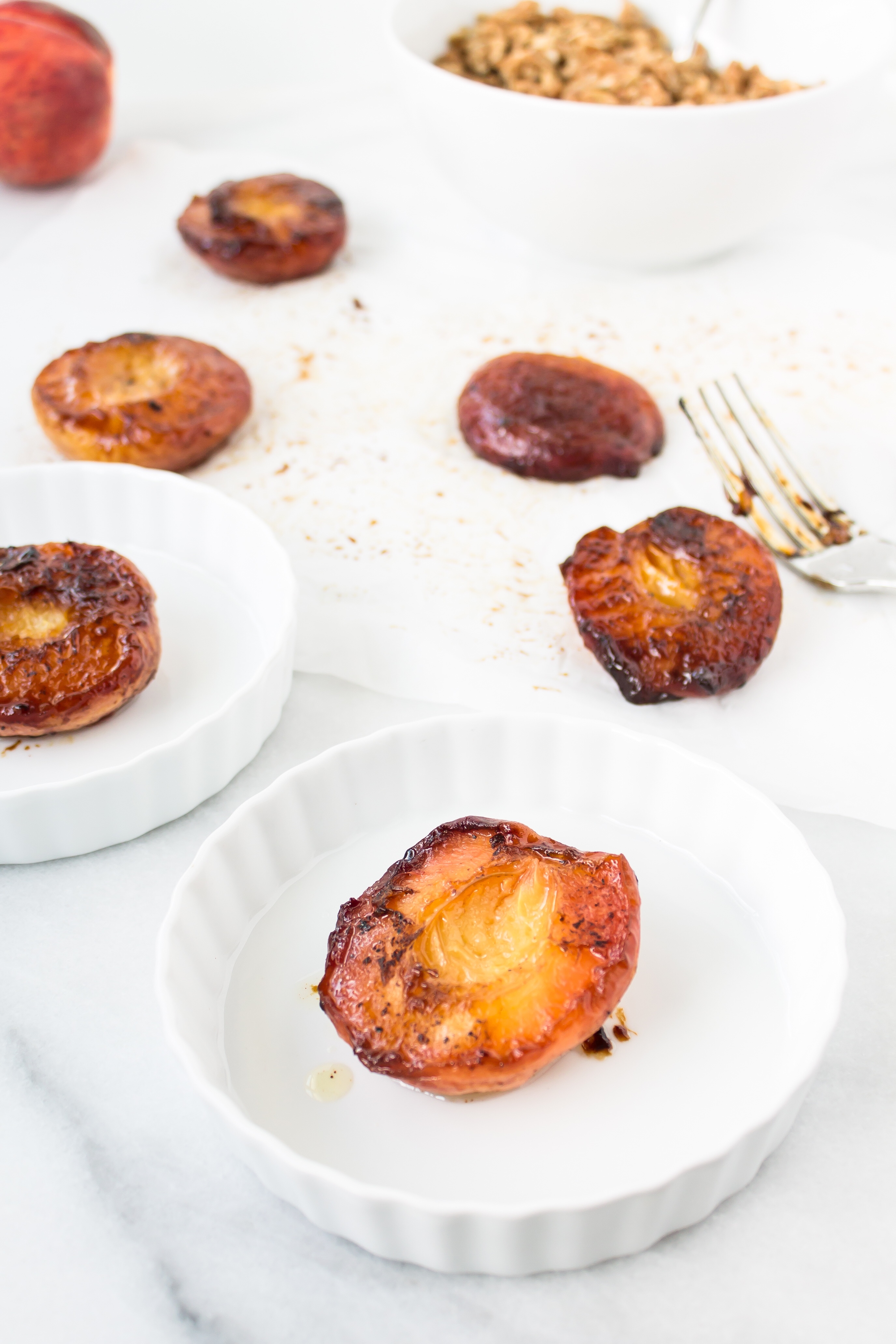 Foodie blogger Lexi of Glitter, Inc. shares the most incredible caramely roasted peaches with yogurt and homemade streusel. Click through for the recipe. | glitterinc.com | @glitterinc