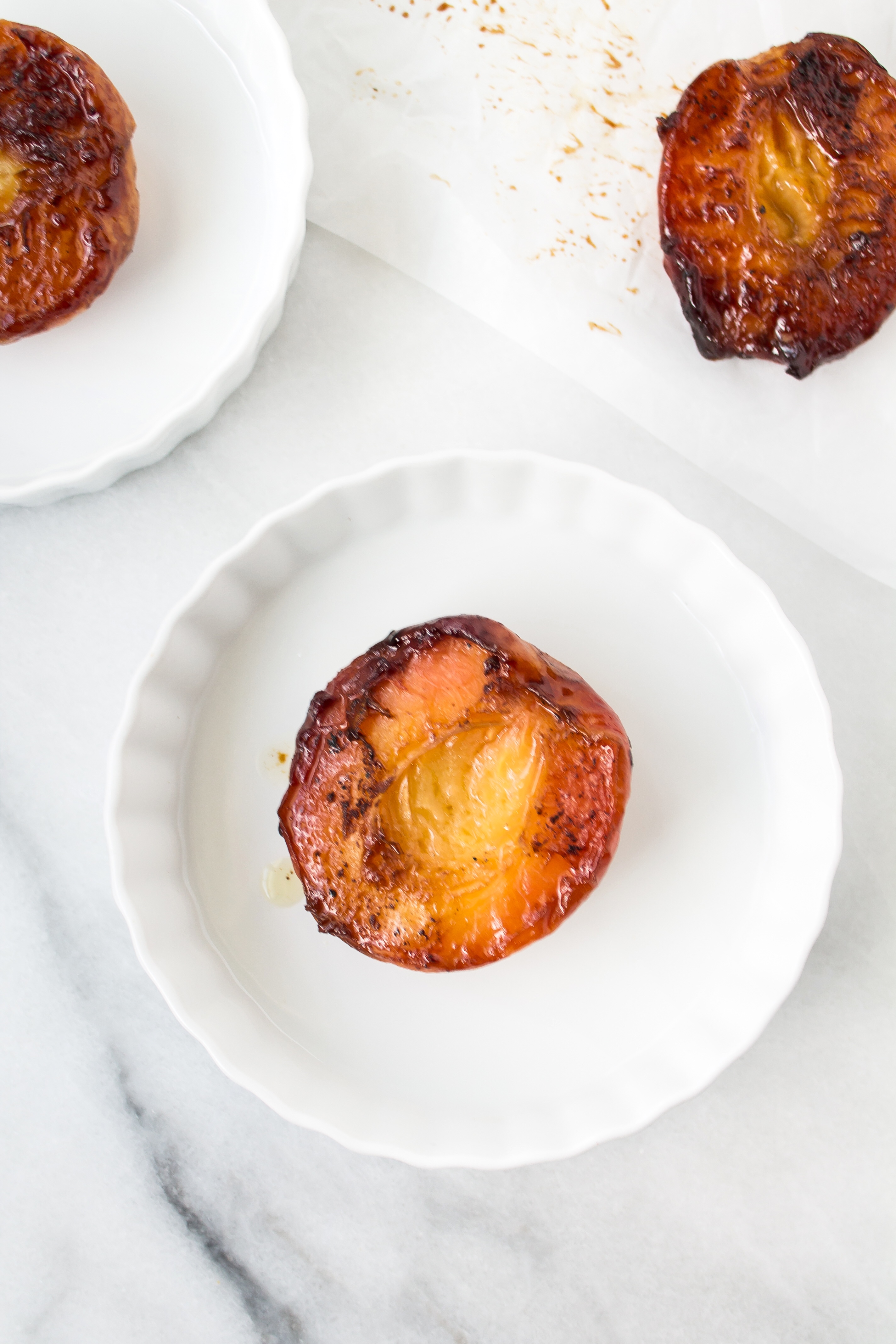 Foodie blogger Lexi of Glitter, Inc. shares the most incredible caramely roasted peaches with yogurt and homemade streusel. Click through for the recipe. | glitterinc.com | @glitterinc