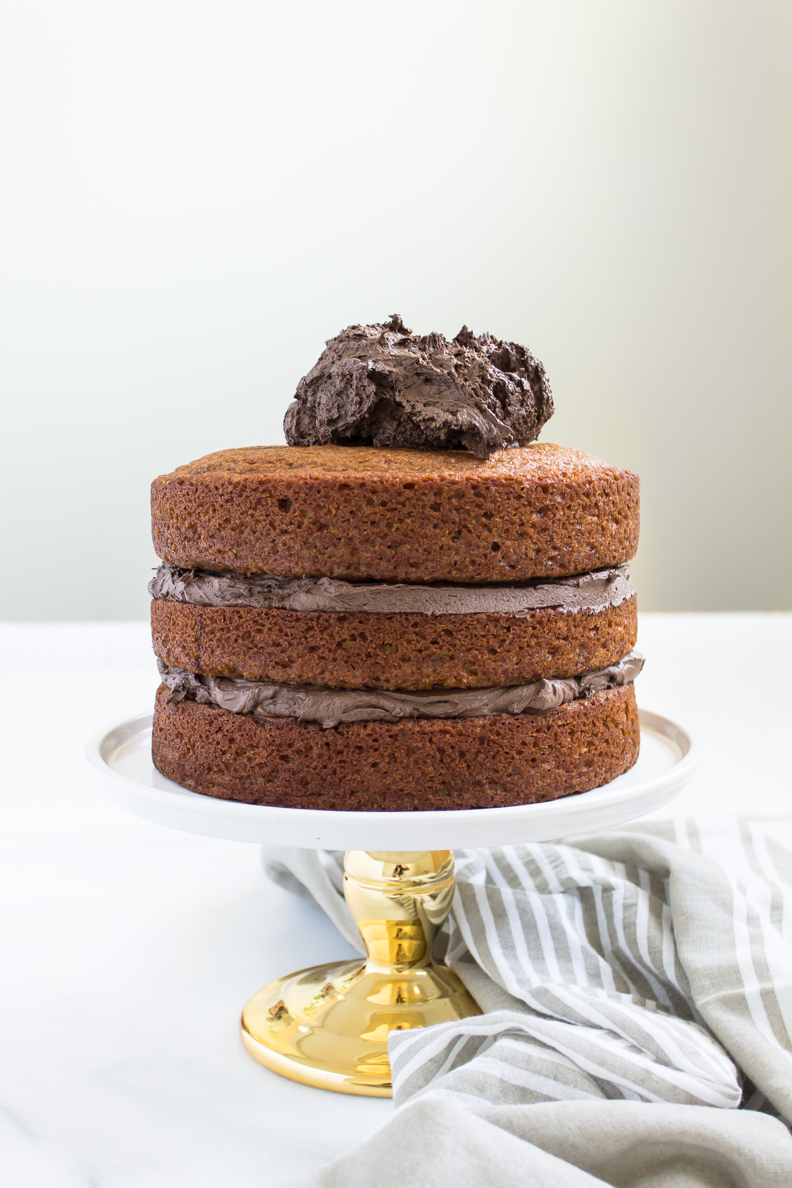 This incredibly moist spiced pumpkin cake topped with a rich and fluffy chocolate frosting is perfect for fall. Click through for the recipe. | glitterinc.com | @glitterinc - Pumpkin Cake Recipe with Fluffy Chocolate Frosting by North Carolina foodie blogger Glitter, Inc.