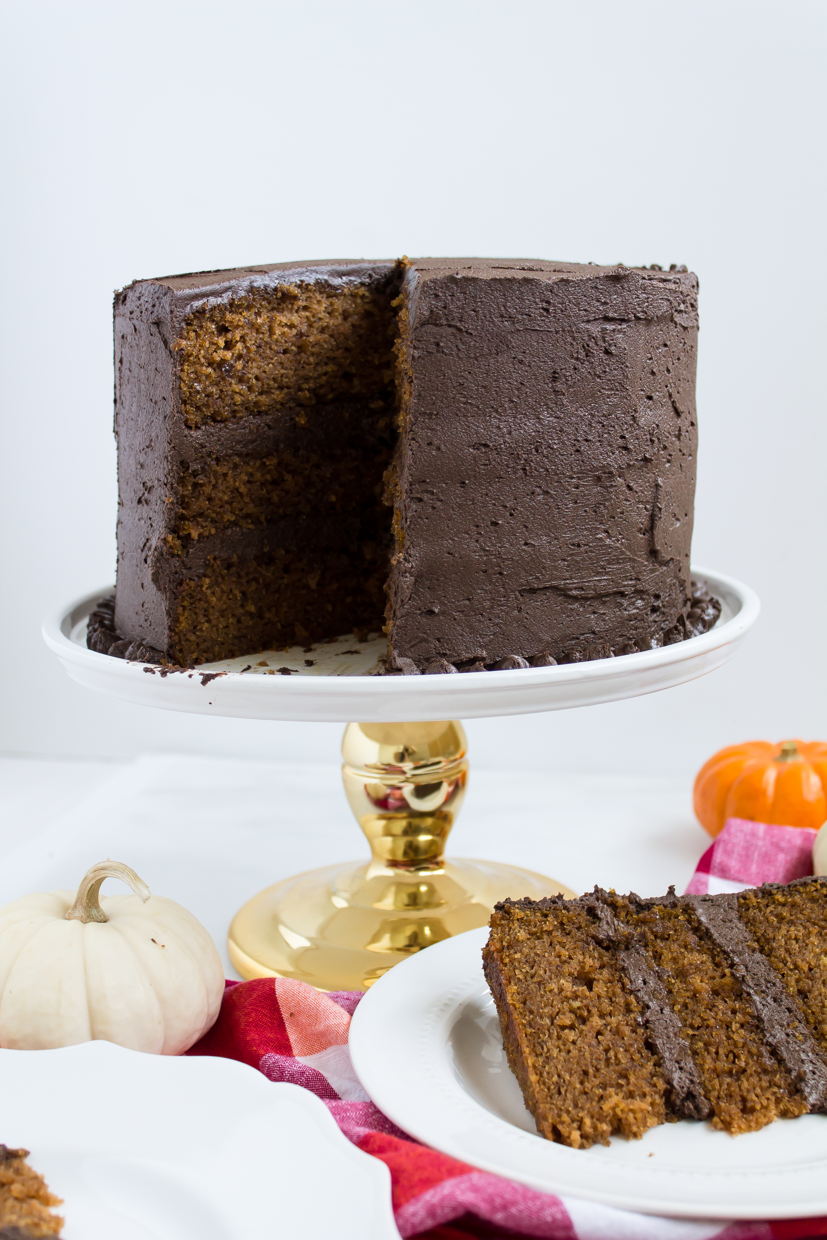 This incredibly moist spiced pumpkin cake topped with a rich and fluffy chocolate frosting is perfect for fall. Click through for the recipe. | glitterinc.com | @glitterinc - Pumpkin Cake Recipe with Fluffy Chocolate Frosting by North Carolina foodie blogger Glitter, Inc.