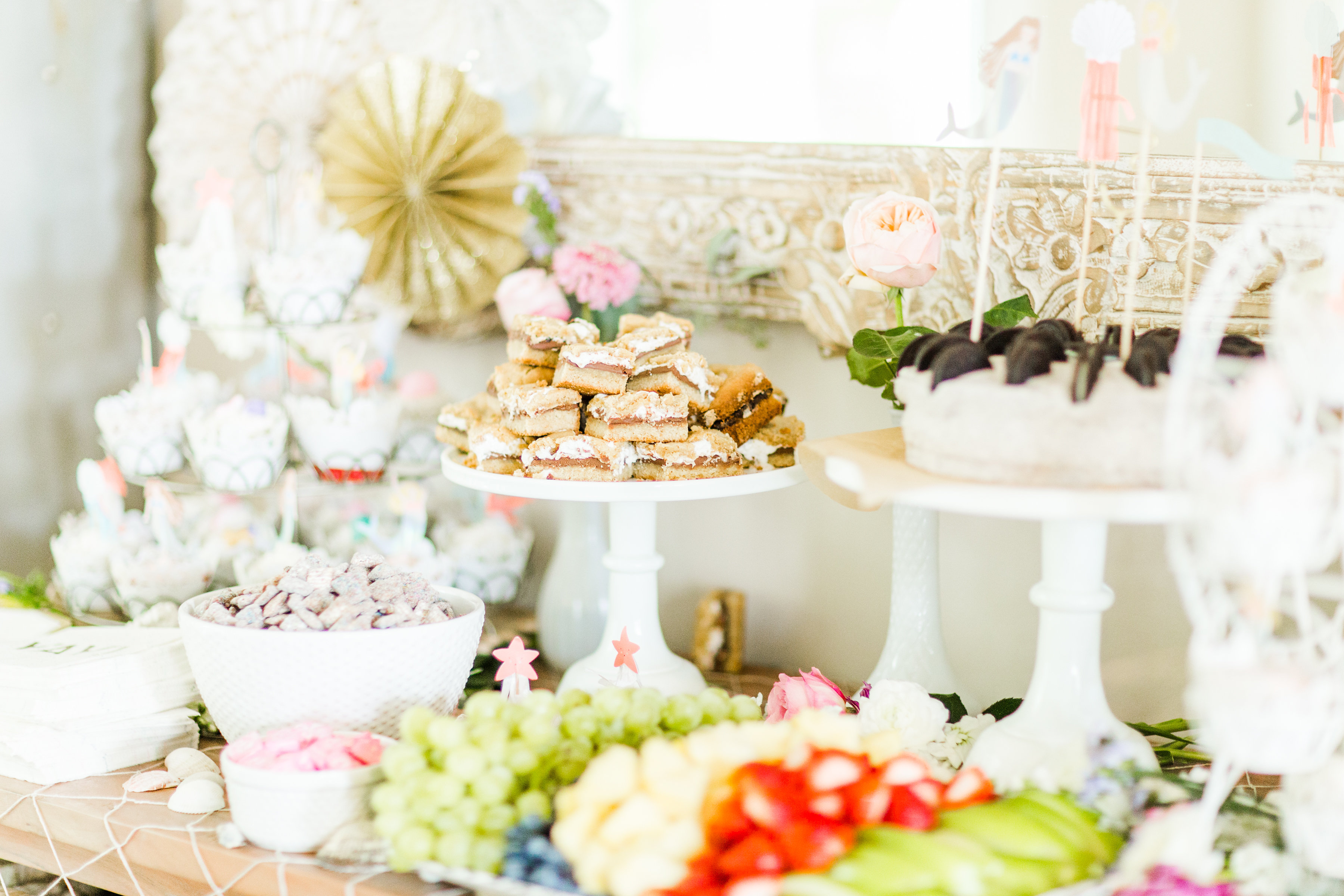 Behind-the-scenes of a magical, whimsical little girl's mermaid birthday party, complete with mermaid dessert bar, games, prizes, and crafts. Click through for the details. | glitterinc.com | @glitterinc