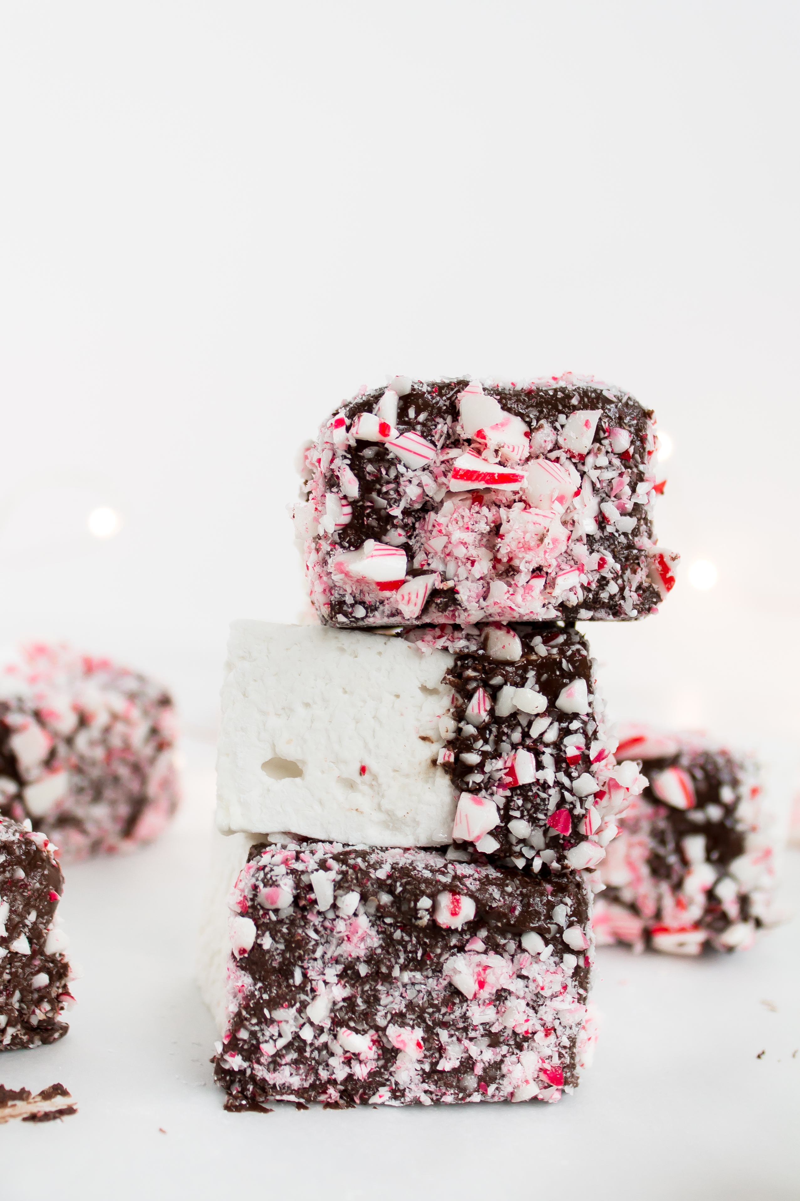 There's nothing like homemade marshmallows. Dipping those fluffy marshmallows in chocolate and crushed peppermint for the holidays is just the icing on the cake ... errr, marshmallow. Click through for the recipe. | glitterinc.com | @glitterinc - Homemade Chocolate Covered Marshmallows with Crushed Peppermint by North Carolina foodie blogger Glitter, Inc.