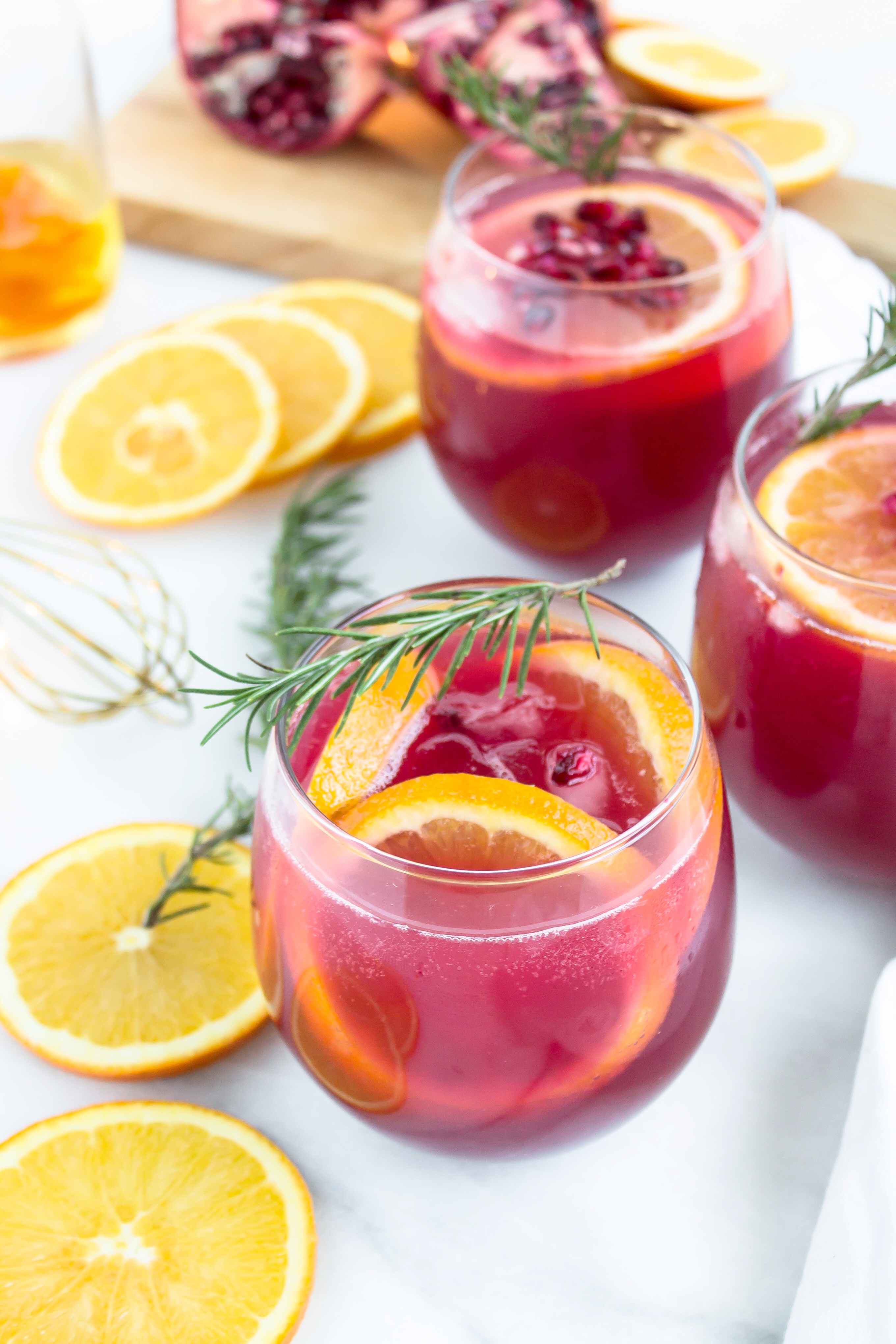 This sparkling pomegranate punch has me doing a little spiked happy dance. It's the perfect holiday cocktail! Click through for the recipe. | glitterinc.com | @glitterinc - Sparkling Pomegranate Punch Cocktails by North Carolina foodie blogger Glitter, Inc.