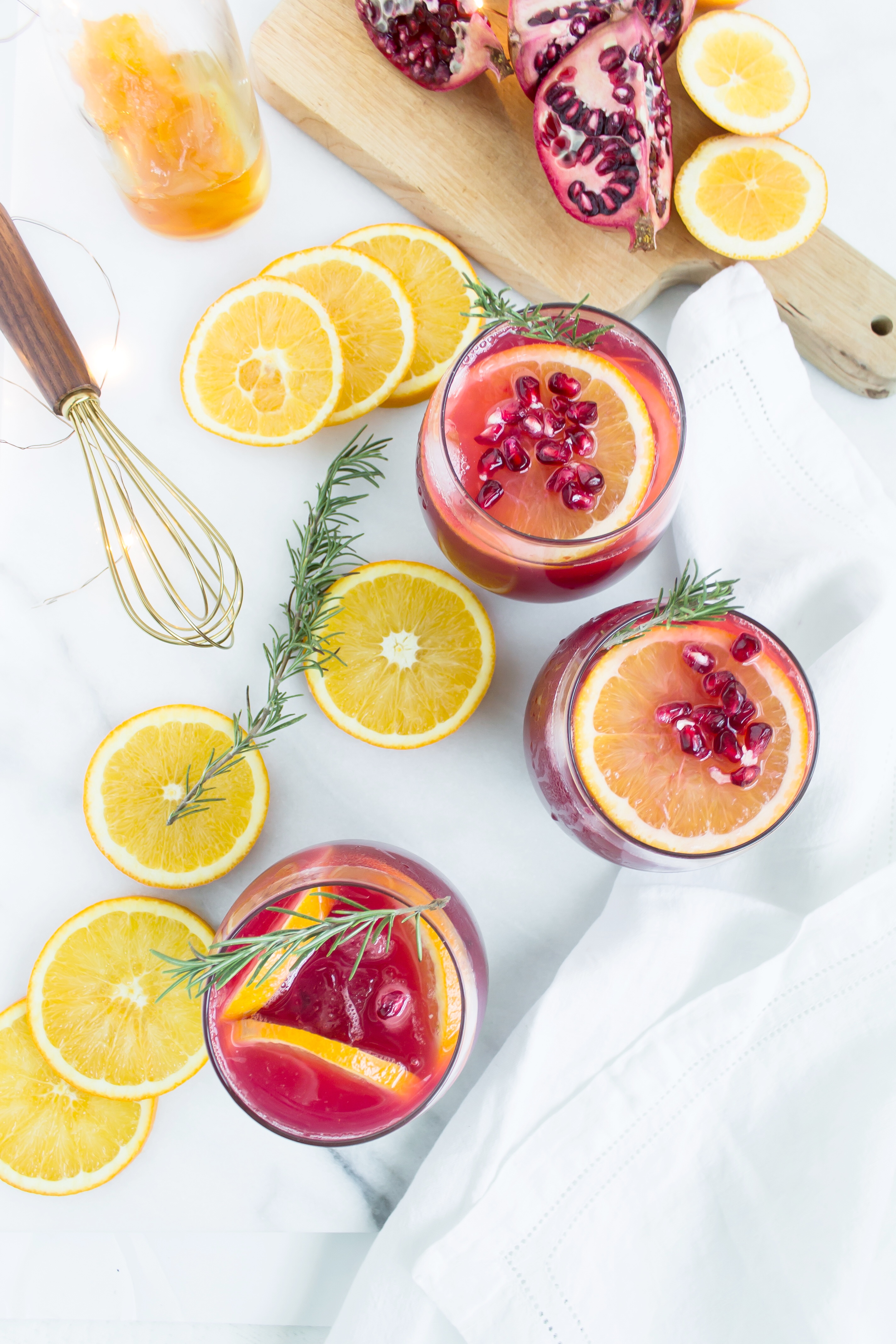 This sparkling pomegranate punch has me doing a little spiked happy dance. It's the perfect holiday cocktail! Click through for the recipe. | glitterinc.com | @glitterinc - Sparkling Pomegranate Punch Cocktails by North Carolina foodie blogger Glitter, Inc.