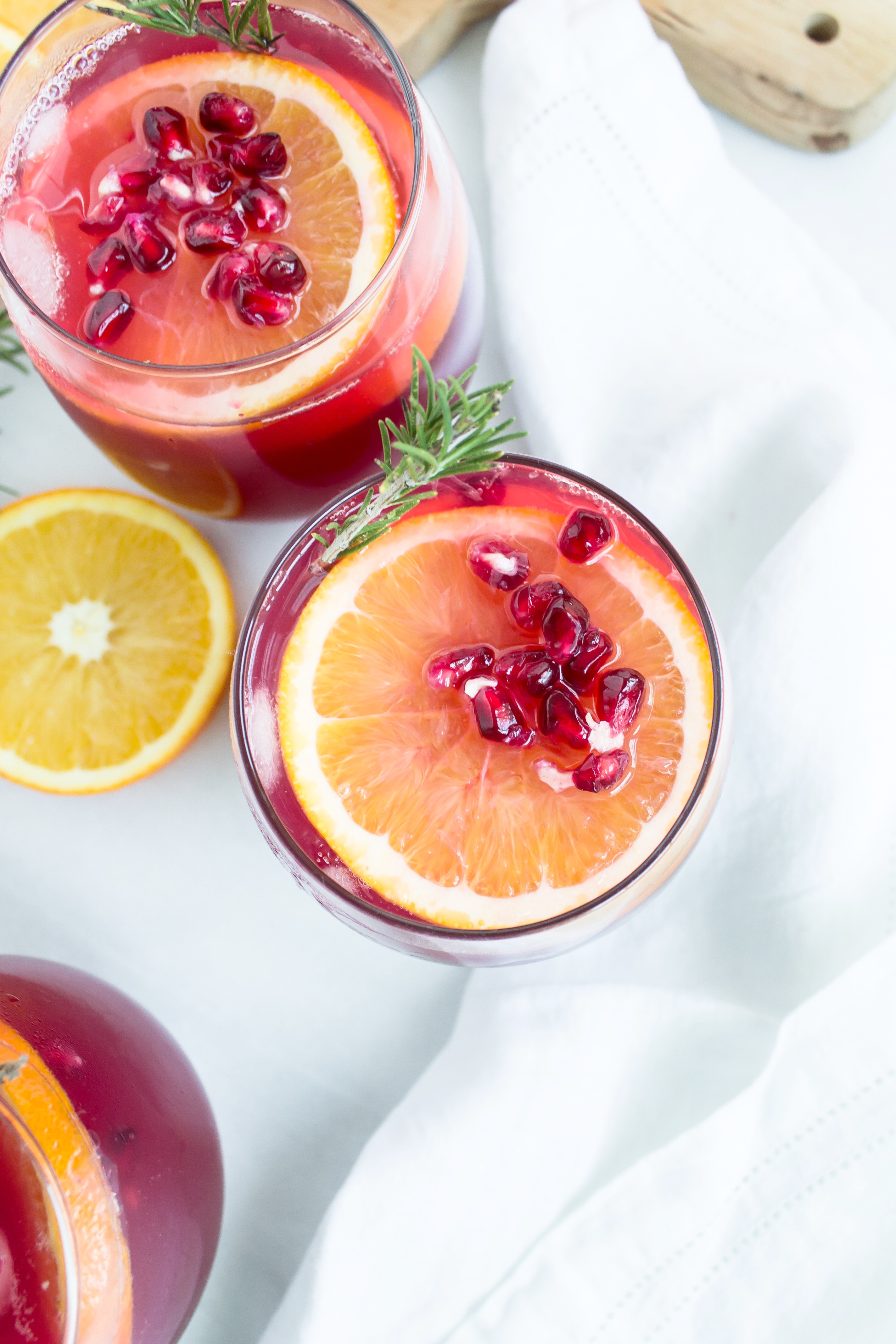 This sparkling pomegranate punch has me doing a little spiked happy dance. It's the perfect holiday cocktail! Click through for the recipe. | glitterinc.com | @glitterinc - Sparkling Pomegranate Punch Cocktails by North Carolina foodie blogger Glitter, Inc.