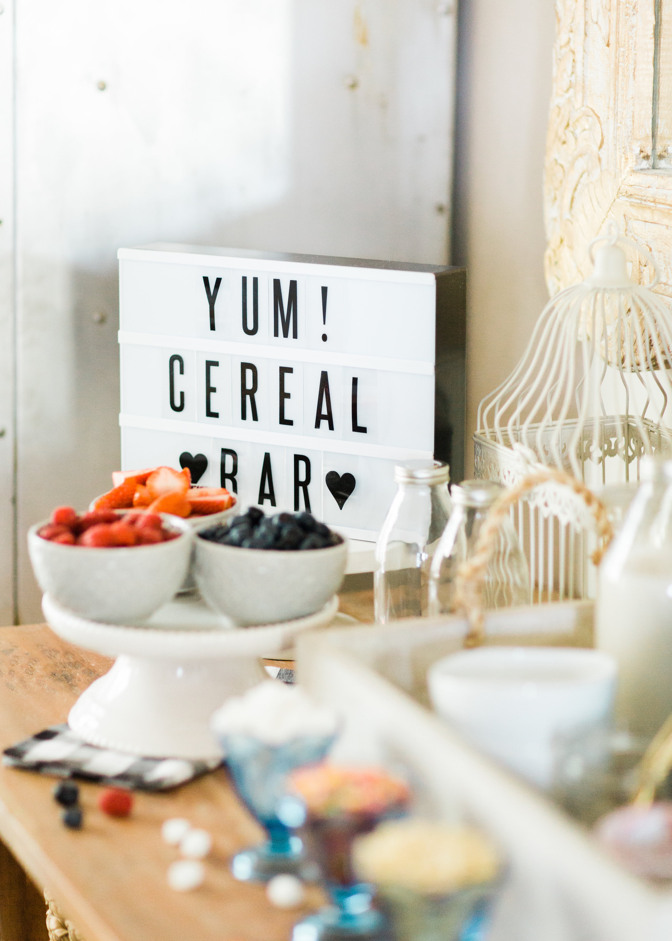 Looking for a unique and easy party dessert station? We're showing you how to put together a DIY retro cereal bar; perfect for a festive and memorable brunch, throwback party, pajama-themed soirée, or sleepover for your kids and their friends! Click through for the details. #brunch #brunchideas #cerealbar #cerealstation #party #partyideas #sleepoverparty #pajamaparty | glitterinc.com | @glitterinc