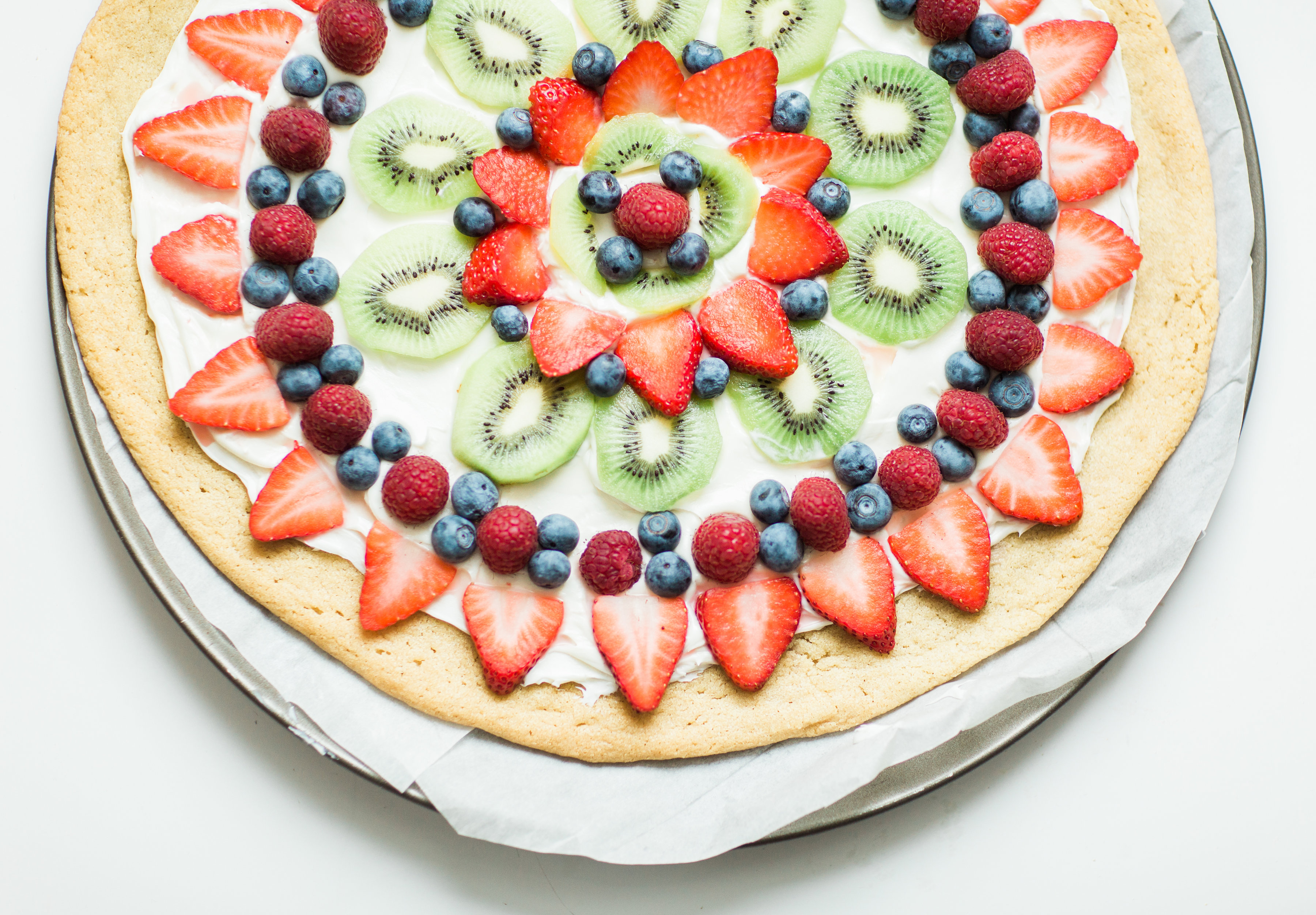 Fruit pizza - a.k.a., dessert pizza - is the kind of dessert everyone will love, and we've made it dairy-free using all simple and loved store-bought items. Click through for the recipe. | glitterinc.com | @glitterinc - Super Simple Dairy-Free Sugar Cookie Fruit Pizza Recipe by popular North Carolina foodie blogger Glitter, Inc.