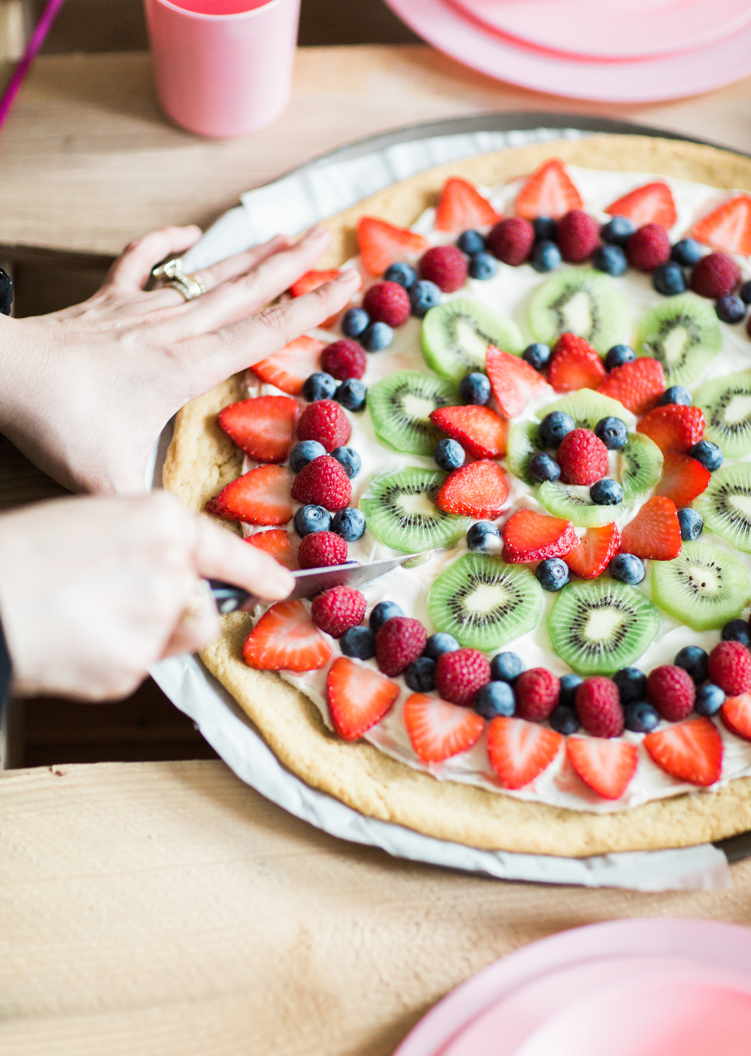 Fruit pizza - a.k.a., dessert pizza - is the kind of dessert everyone will love, and we've made it dairy-free using all simple and loved store-bought items. Click through for the recipe. | glitterinc.com | @glitterinc - Super Simple Dairy-Free Sugar Cookie Fruit Pizza Recipe by popular North Carolina foodie blogger Glitter, Inc.