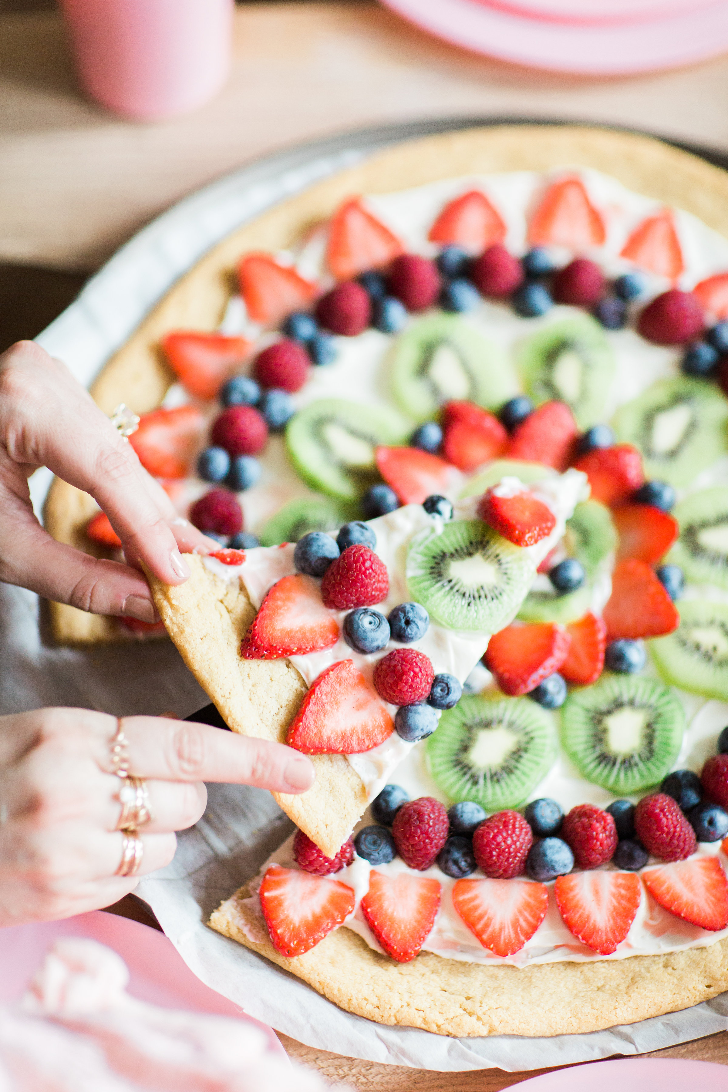 Fruit pizza - a.k.a., dessert pizza - is the kind of dessert everyone will love, and we've made it dairy-free using all simple and loved store-bought items. Click through for the recipe. | glitterinc.com | @glitterinc - Super Simple Dairy-Free Sugar Cookie Fruit Pizza Recipe by popular North Carolina foodie blogger Glitter, Inc.