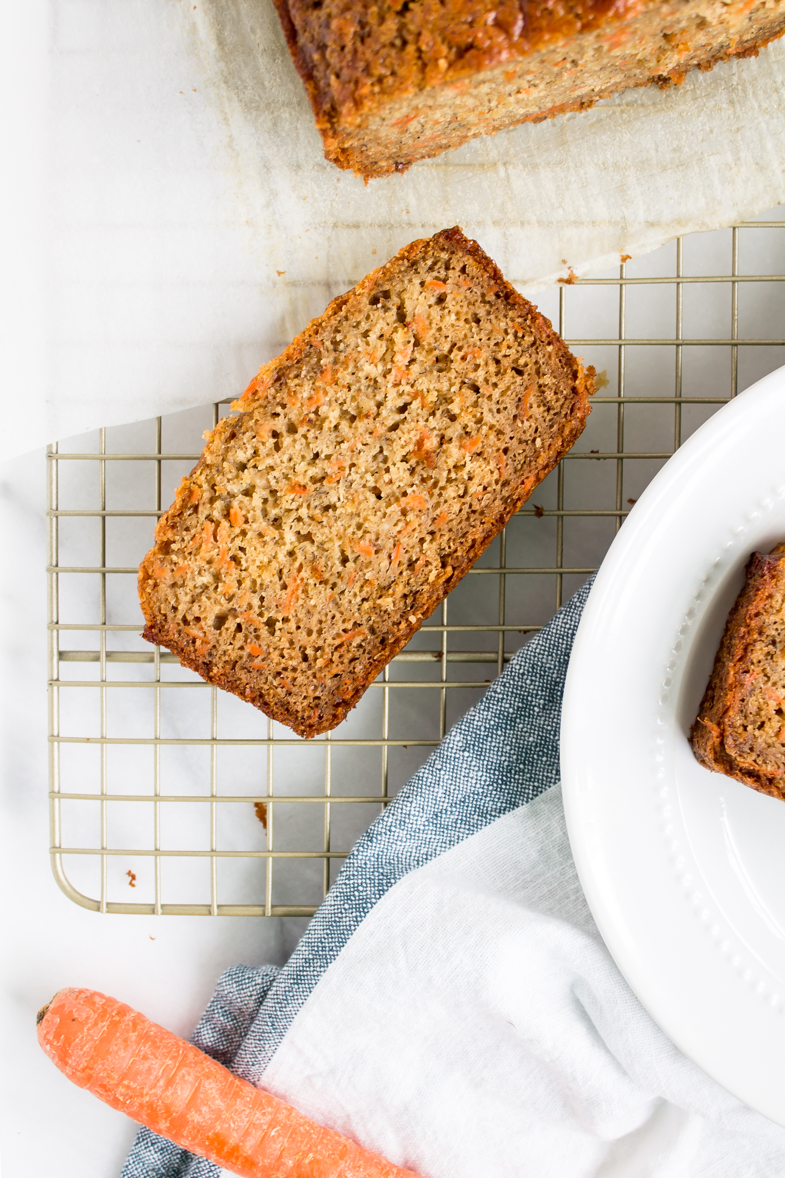 Love carrot cake? Love banana bread? This cross between a delicious carrot cake and your favorite moist slice of classic banana bread is going to become a fast favorite. Click through for the recipe. | glitterinc.com | @glitterinc - Carrot Banana Bread by popular North Carolina foodie blog Glitter, Inc.