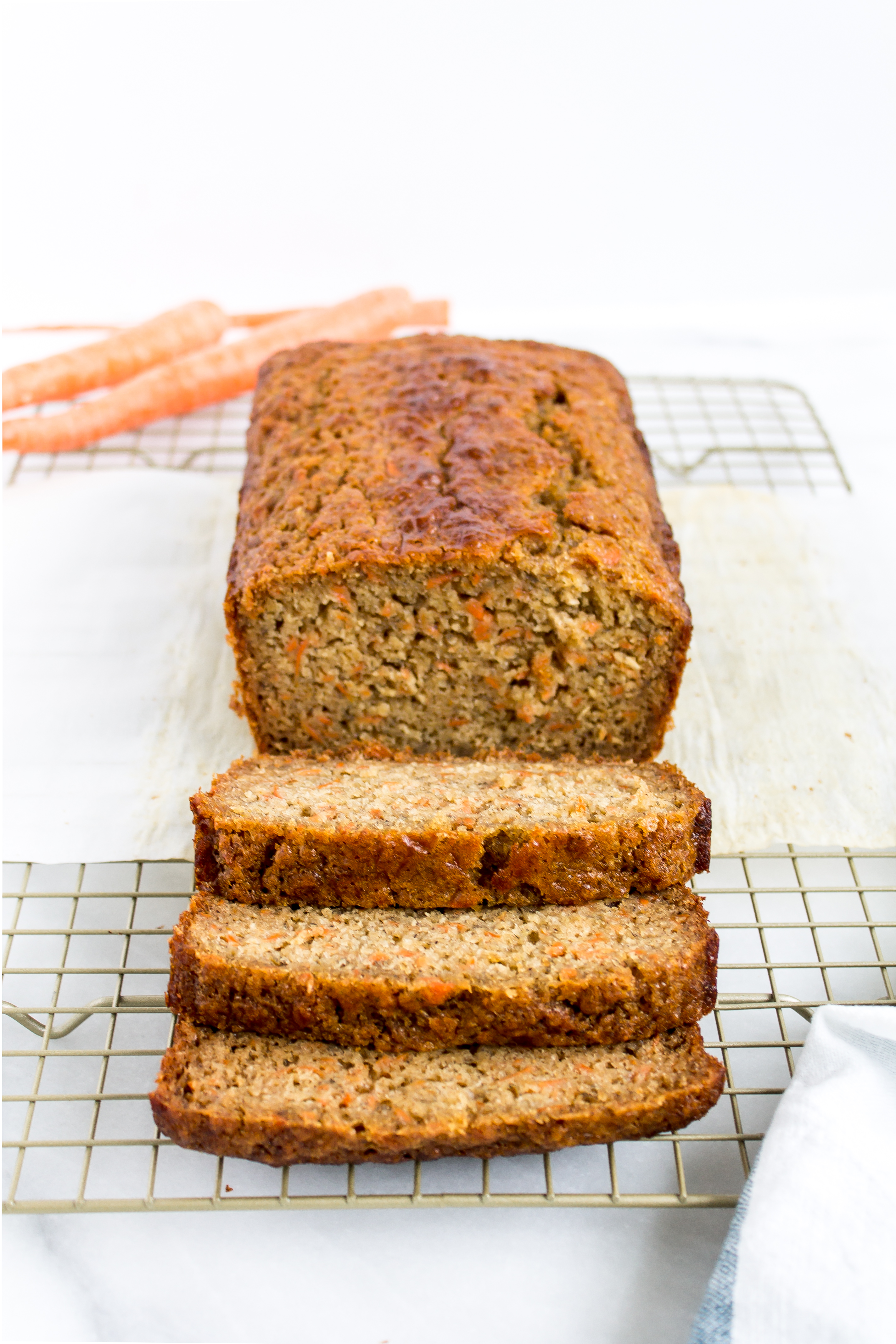 Love carrot cake? Love banana bread? This cross between a delicious carrot cake and your favorite moist slice of classic banana bread is going to become a fast favorite. Click through for the recipe. | glitterinc.com | @glitterinc - Carrot Banana Bread by popular North Carolina foodie blog Glitter, Inc.