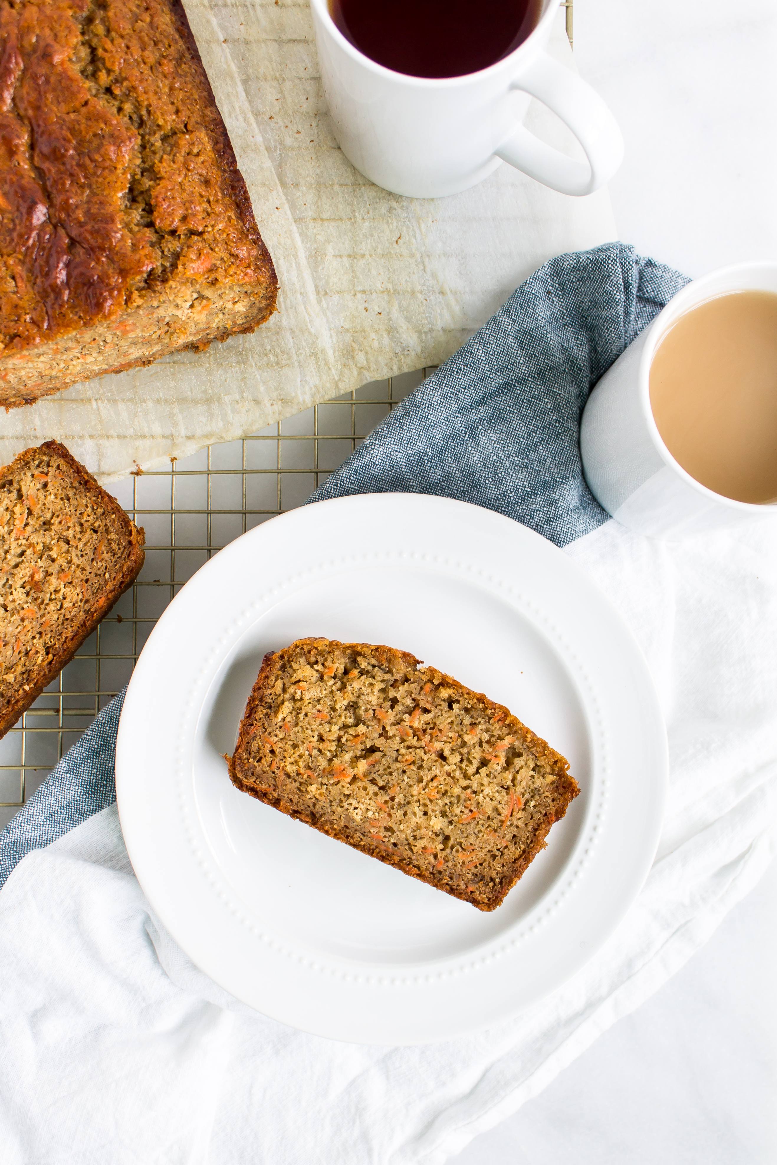 Love carrot cake? Love banana bread? This cross between a delicious carrot cake and your favorite moist slice of classic banana bread is going to become a fast favorite. Click through for the recipe. | glitterinc.com | @glitterinc - Carrot Banana Bread by popular North Carolina foodie blog Glitter, Inc.