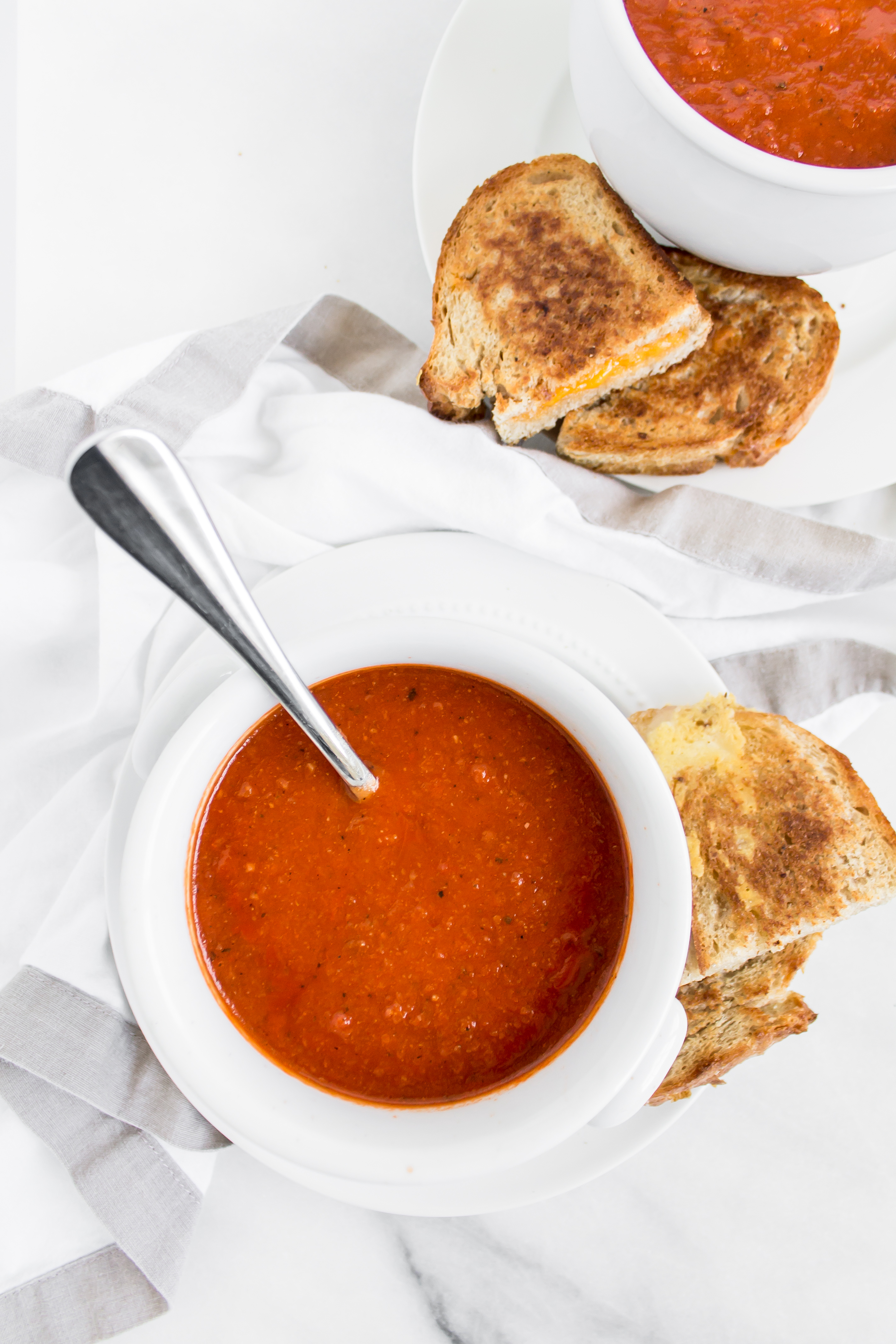 Looking for an easy and delicious healthier soup for dinner? You'll love this spin on classic tomato soup. It's dairy-free using one very cool secret ingredient that keeps it healthier and protein-packed. Click through for the recipe. | glitterinc.com | @glitterinc - Healthier Protein-Packed Classic Tomato Soup by popular North Carolina foodie blogger Glitter, Inc.