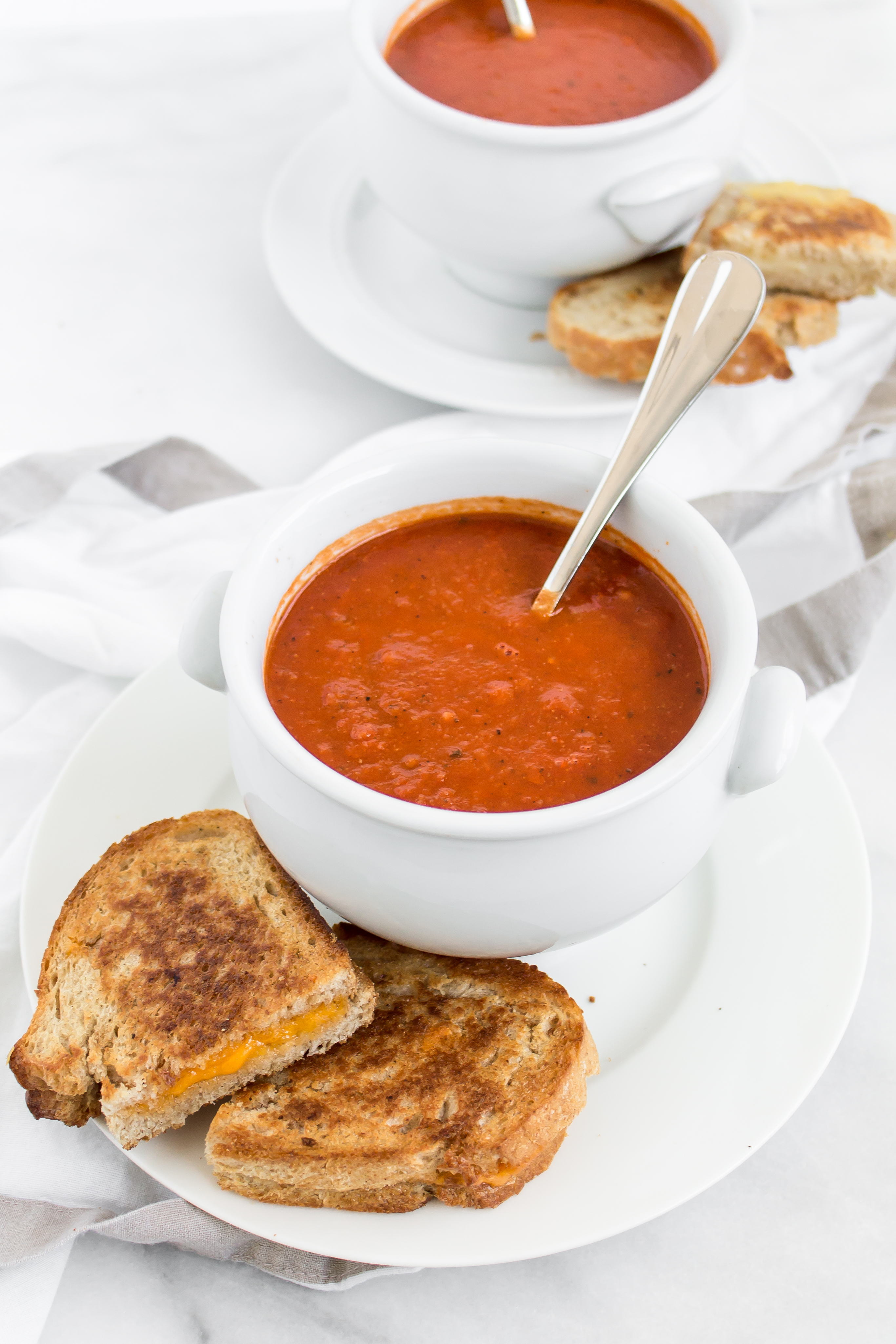 Looking for an easy and delicious healthier soup for dinner? You'll love this spin on classic tomato soup. It's dairy-free using one very cool secret ingredient that keeps it healthier and protein-packed. Click through for the recipe. | glitterinc.com | @glitterinc - Healthier Protein-Packed Classic Tomato Soup by popular North Carolina foodie blogger Glitter, Inc.