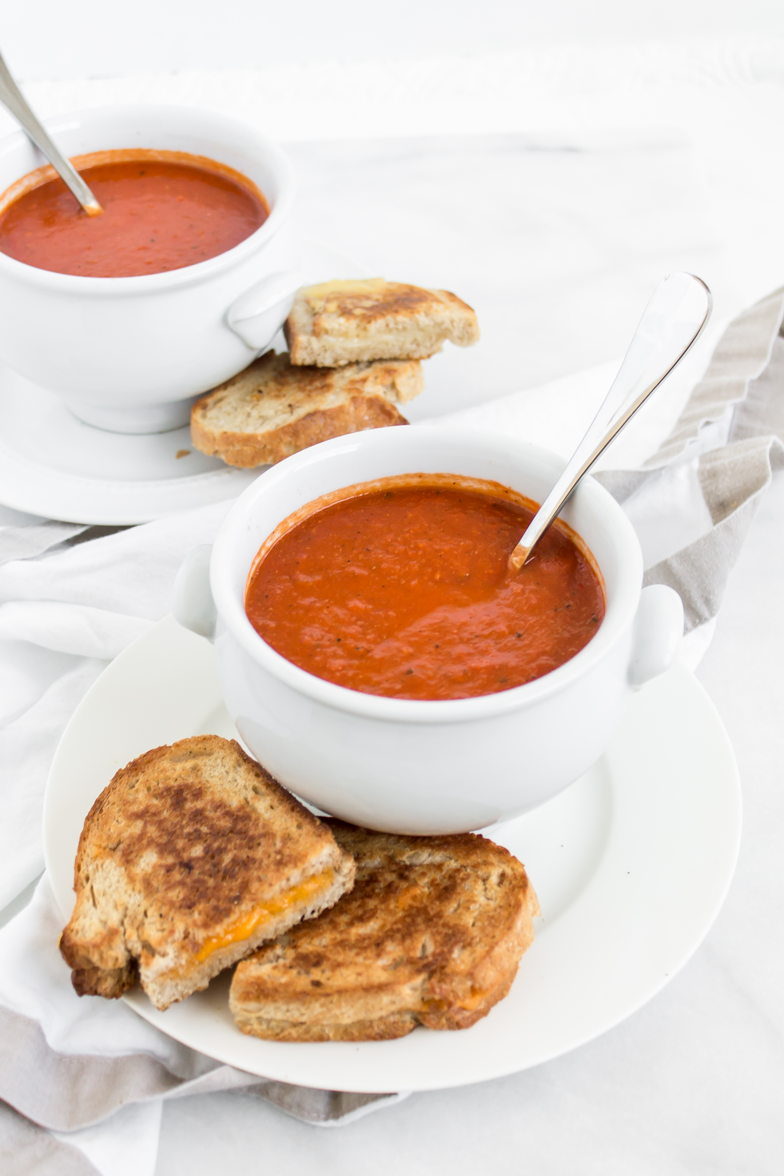 Looking for an easy and delicious healthier soup for dinner? You'll love this spin on classic tomato soup. It's dairy-free using one very cool secret ingredient that keeps it healthier and protein-packed. Click through for the recipe. | glitterinc.com | @glitterinc - Healthier Protein-Packed Classic Tomato Soup by popular North Carolina foodie blogger Glitter, Inc.