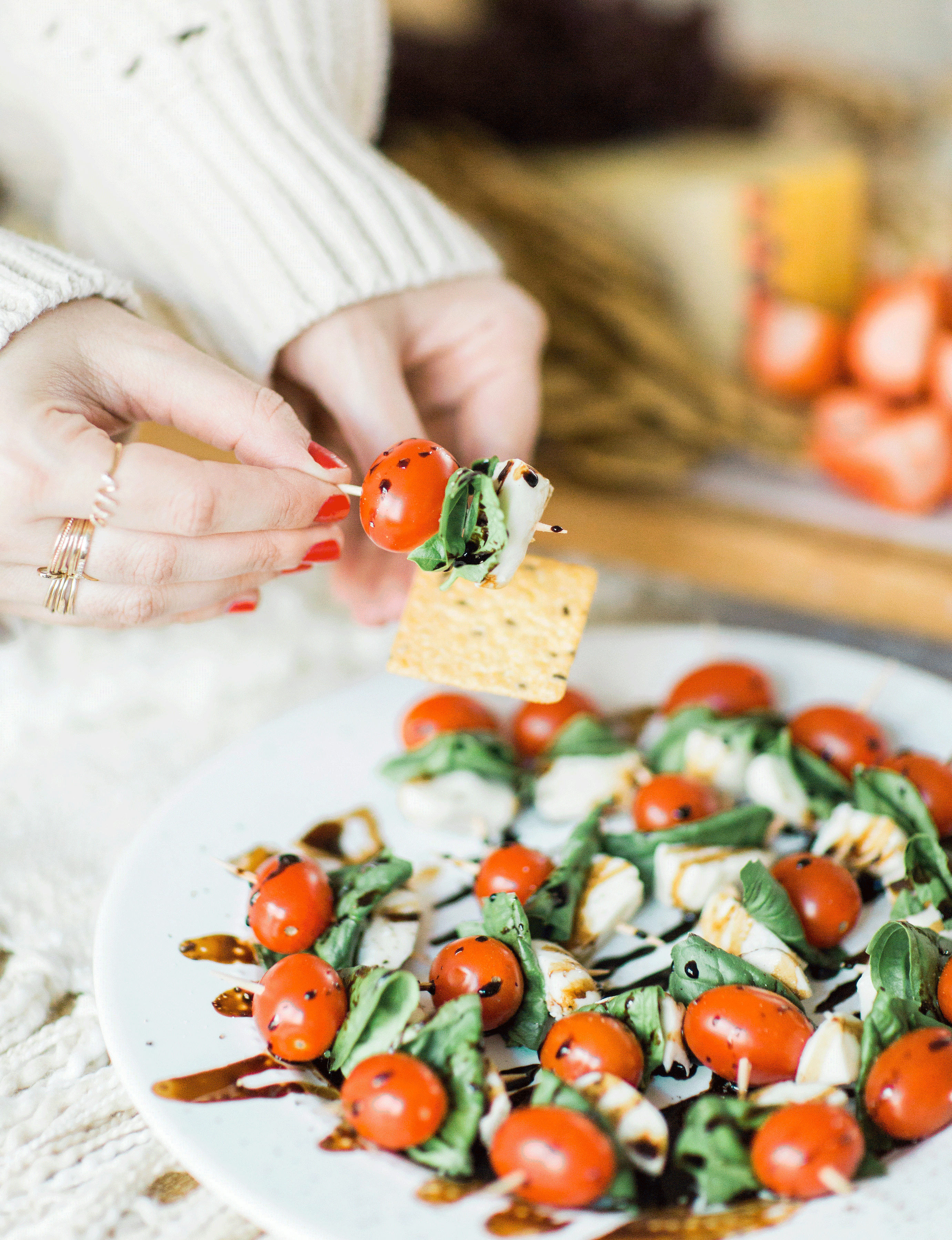 Need a super simple appetizer for your next party? These caprese skewers with balsamic drizzle couldn't be easier to put together, taste absolutely delicious, and are always a perfect crowd-pleaser! Click through for the recipe. | glitterinc.com | @glitterinc - Caprese Skewers With Balsamic Glaze featured by popular North Carolina food blogger, Glitter, Inc.