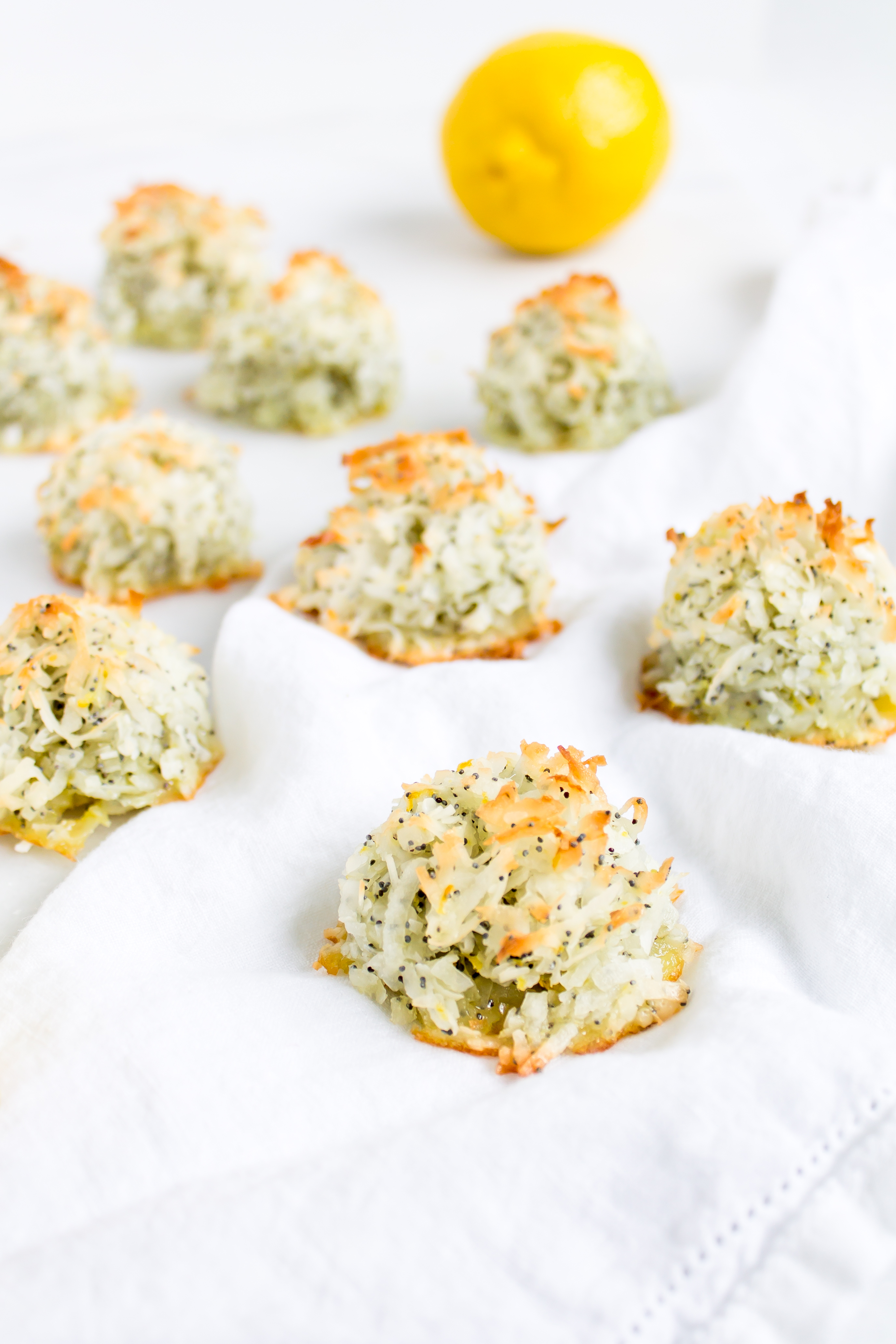 Coconut macaroons have the perfect balance of textures - crunchy on the outside, but moist and chewy on the inside. This lemon poppy seed version of the classic flourless cookie is packed with fresh, zesty citrus flavor for a wonderful spring or Passover treat! Click through for the recipe. | glitterinc.com | @glitterinc - Lemon Poppyseed Coconut Macaroons Recipe by popular North Carolina foodie blog Glitter, Inc.