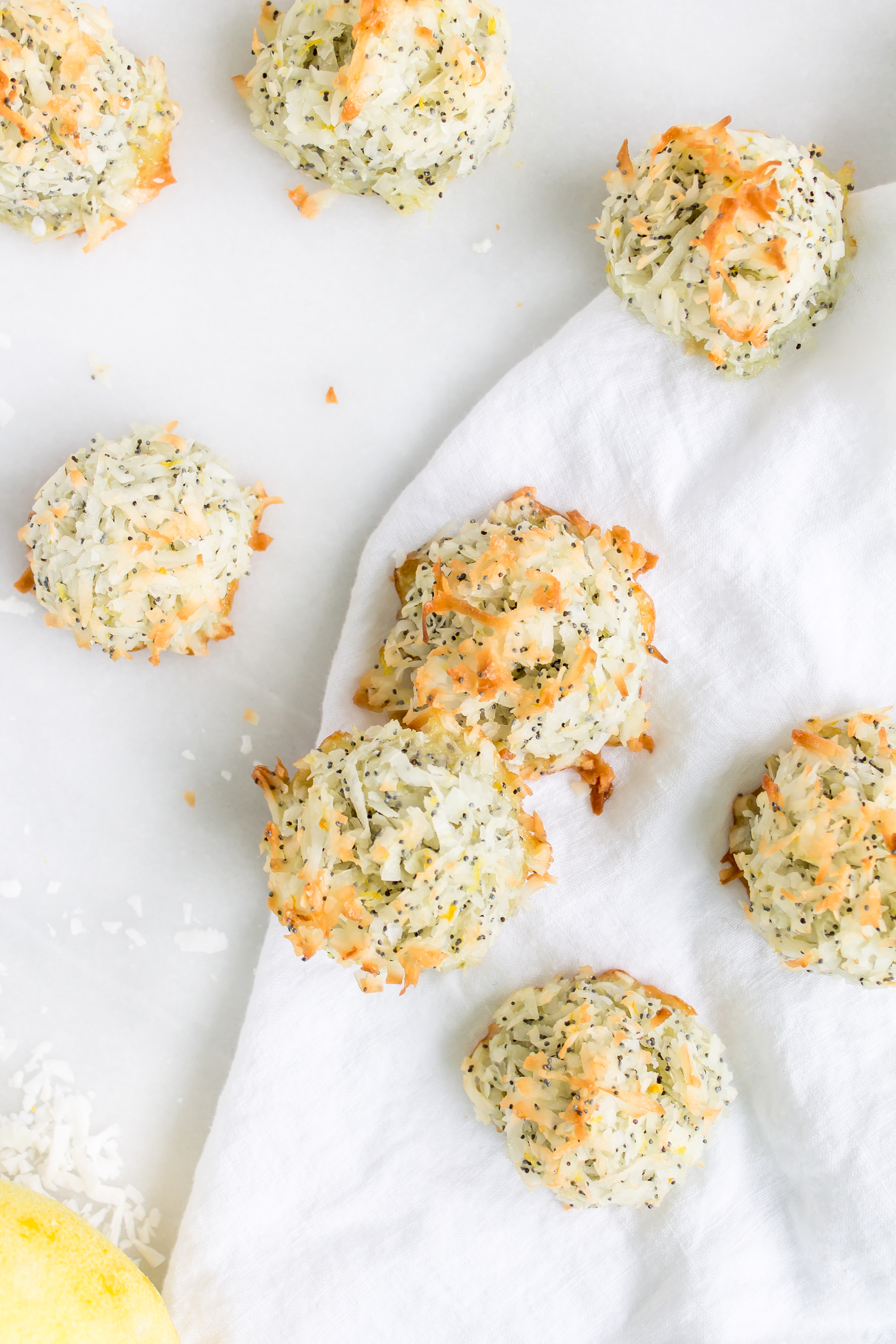 Coconut macaroons have the perfect balance of textures - crunchy on the outside, but moist and chewy on the inside. This lemon poppy seed version of the classic flourless cookie is packed with fresh, zesty citrus flavor for a wonderful spring or Passover treat! Click through for the recipe. | glitterinc.com | @glitterinc - Lemon Poppyseed Coconut Macaroons Recipe by popular North Carolina foodie blog Glitter, Inc.