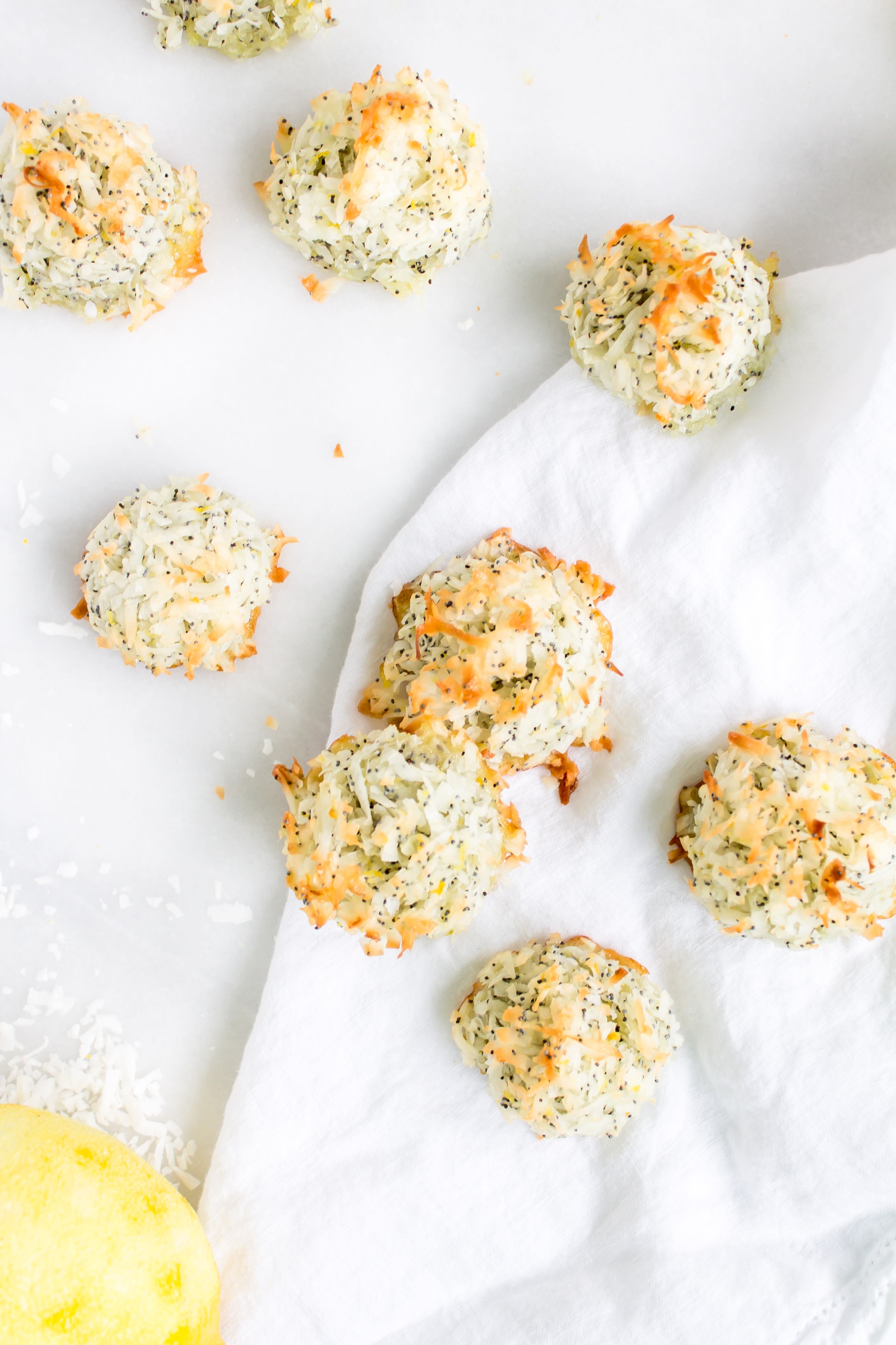 Coconut macaroons have the perfect balance of textures - crunchy on the outside, but moist and chewy on the inside. This lemon poppy seed version of the classic flourless cookie is packed with fresh, zesty citrus flavor for a wonderful spring or Passover treat! Click through for the recipe. | glitterinc.com | @glitterinc - Lemon Poppyseed Coconut Macaroons Recipe by popular North Carolina foodie blog Glitter, Inc.