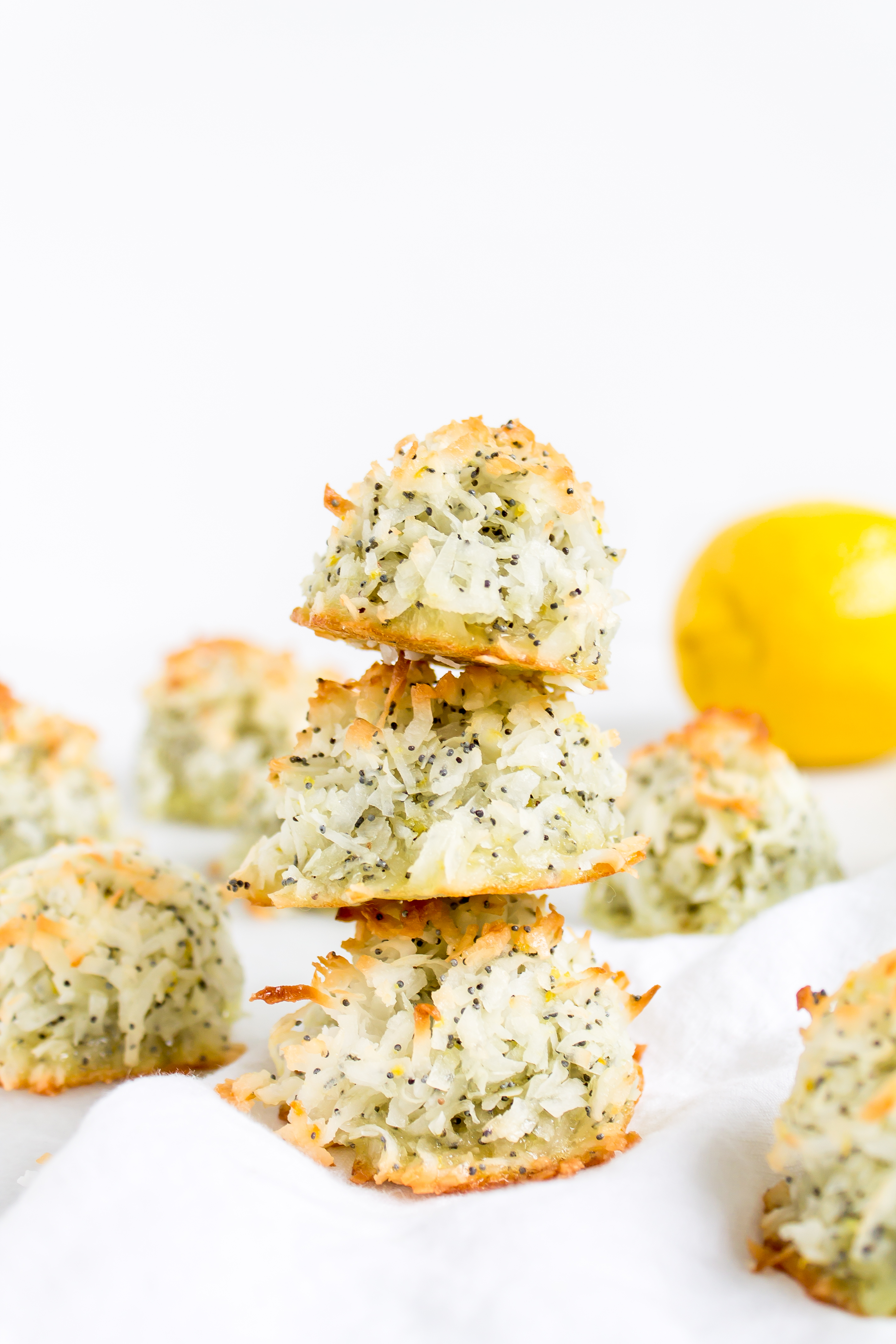 Coconut macaroons have the perfect balance of textures - crunchy on the outside, but moist and chewy on the inside. This lemon poppy seed version of the classic flourless cookie is packed with fresh, zesty citrus flavor for a wonderful spring or Passover treat! Click through for the recipe. | glitterinc.com | @glitterinc - Lemon Poppyseed Coconut Macaroons Recipe by popular North Carolina foodie blog Glitter, Inc.