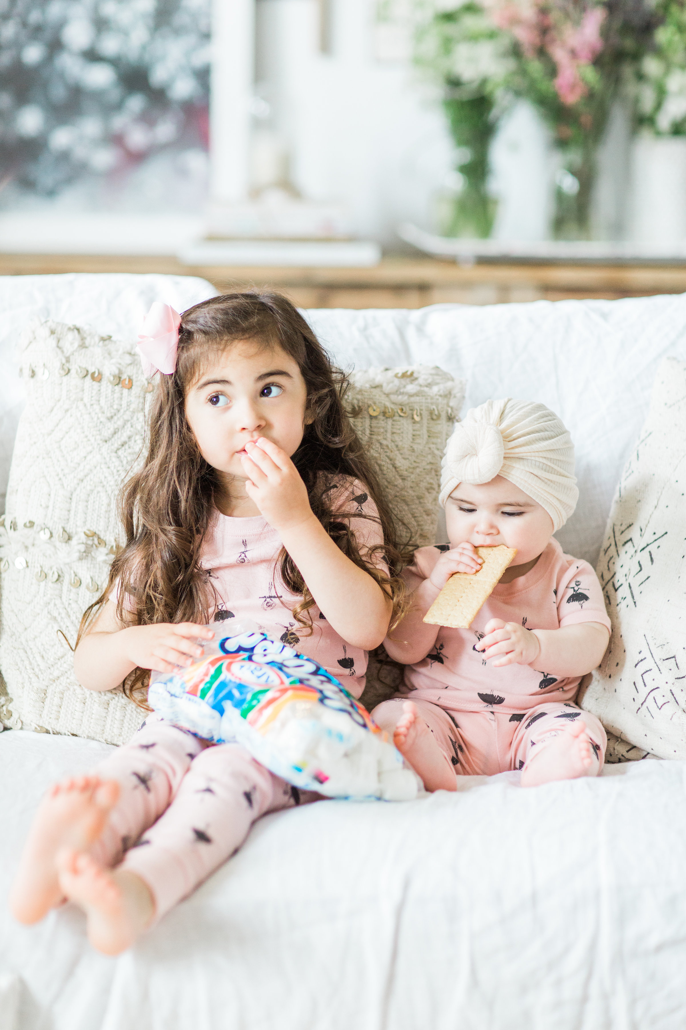 I'm sharing a big 'ol dose of cuteness; a.k.a., the behind-the-scenes of the girls trying s'mores for the first time (and caught on camera) from our family movie night! #smores #matchingpajamas #movienight #familyfun #smoresparty | glitterinc.com | @glitterinc