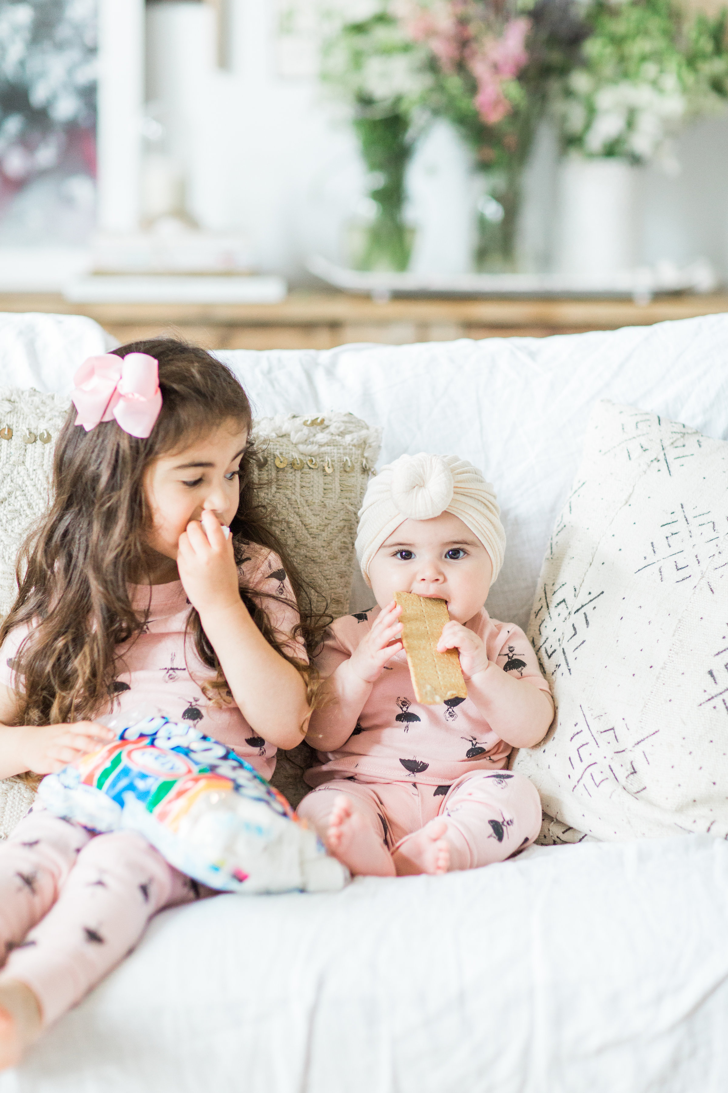 I'm sharing a big 'ol dose of cuteness; a.k.a., the behind-the-scenes of the girls trying s'mores for the first time (and caught on camera) from our family movie night! #smores #matchingpajamas #movienight #familyfun #smoresparty | glitterinc.com | @glitterinc