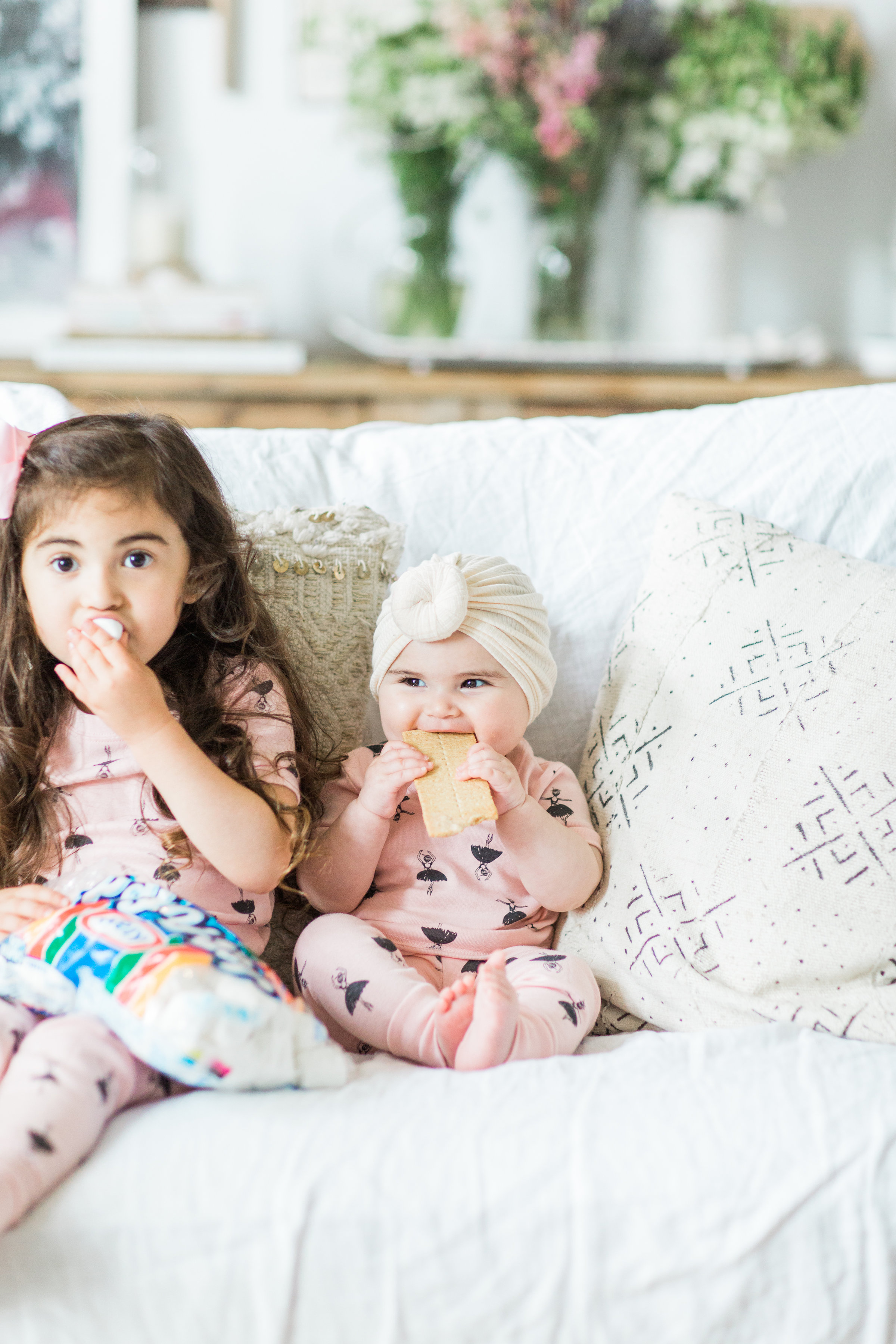 I'm sharing a big 'ol dose of cuteness; a.k.a., the behind-the-scenes of the girls trying s'mores for the first time (and caught on camera) from our family movie night! #smores #matchingpajamas #movienight #familyfun #smoresparty | glitterinc.com | @glitterinc