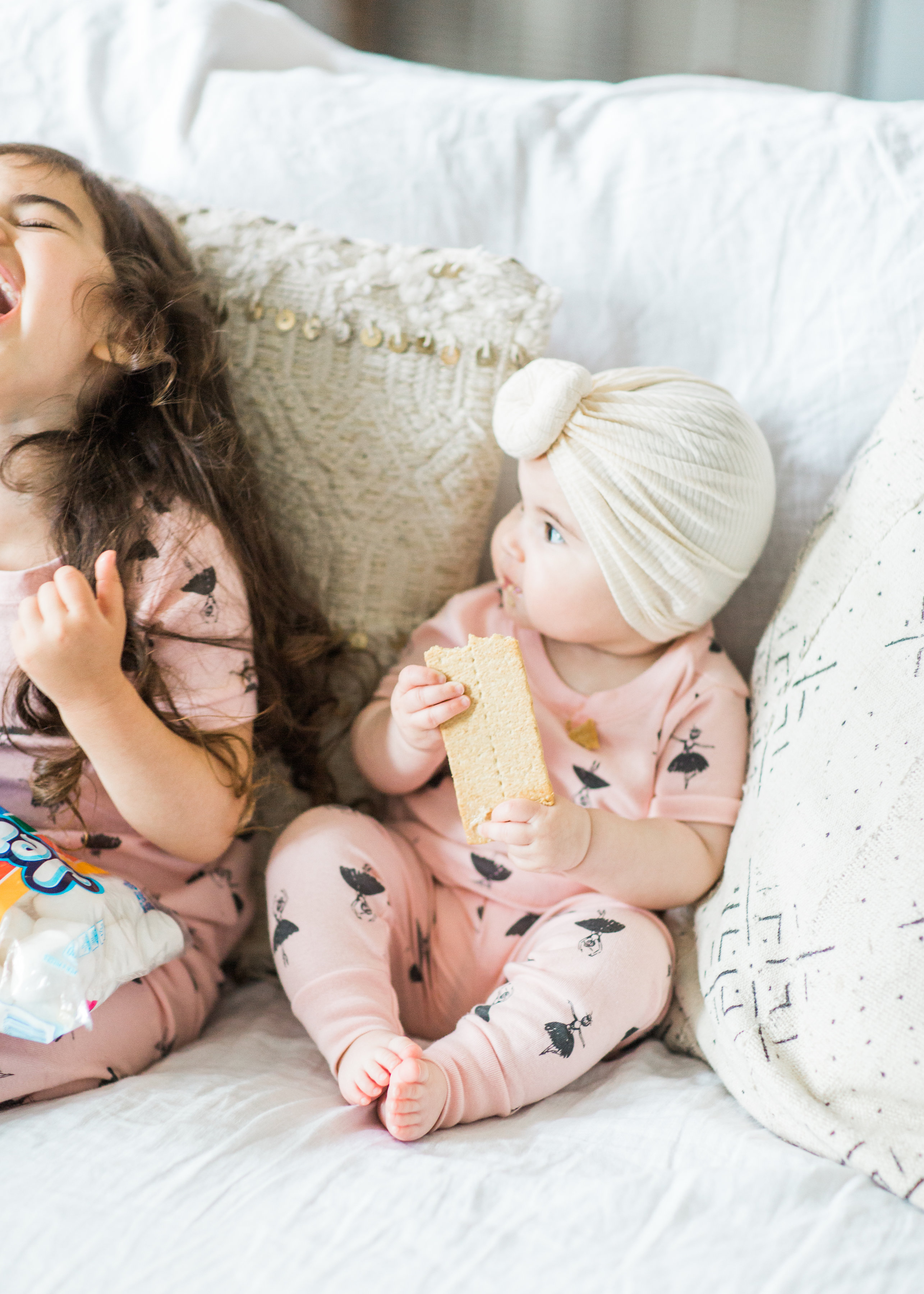 I'm sharing a big 'ol dose of cuteness; a.k.a., the behind-the-scenes of the girls trying s'mores for the first time (and caught on camera) from our family movie night! #smores #matchingpajamas #movienight #familyfun #smoresparty | glitterinc.com | @glitterinc