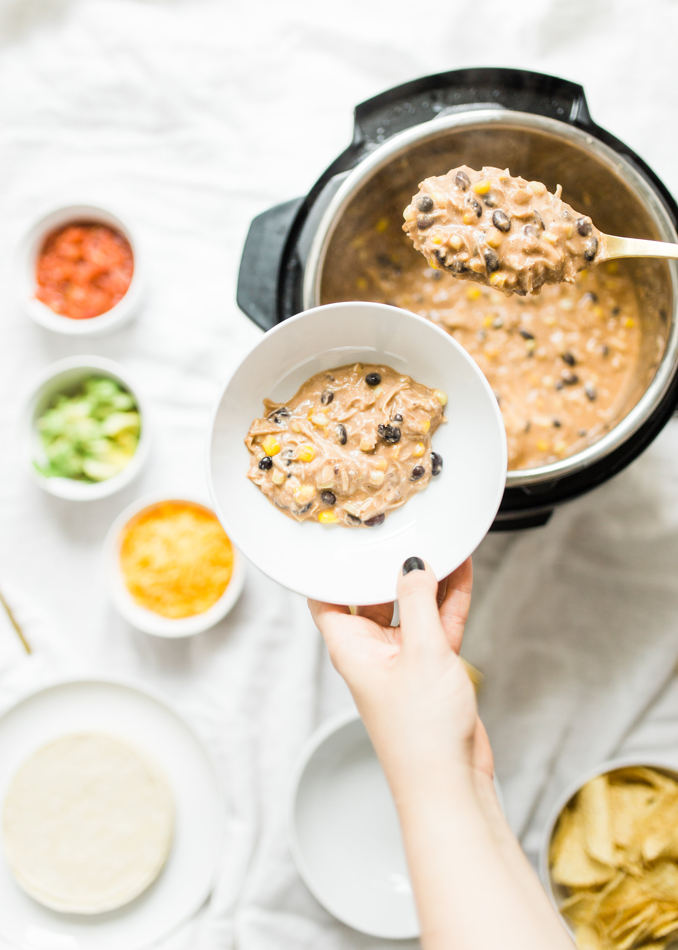 This easy and delicious creamy chicken enchilada soup is made in a crockpot or Instant Pot - a.k.a., dump it and forget it. Our whole family loves it. #crockpot #crockpotmeals #crockpotdinner #instantpot #instantpotdinner #instantpotchicken #crockpotchicken #chickenenchiladas #crockpotenchiladas #instantpotenchiladas #slowcooker #slowcookersoup #slowcookerenchiladas #slowcookermeals Click through for the recipe. | glitterinc.com | @glitterinc