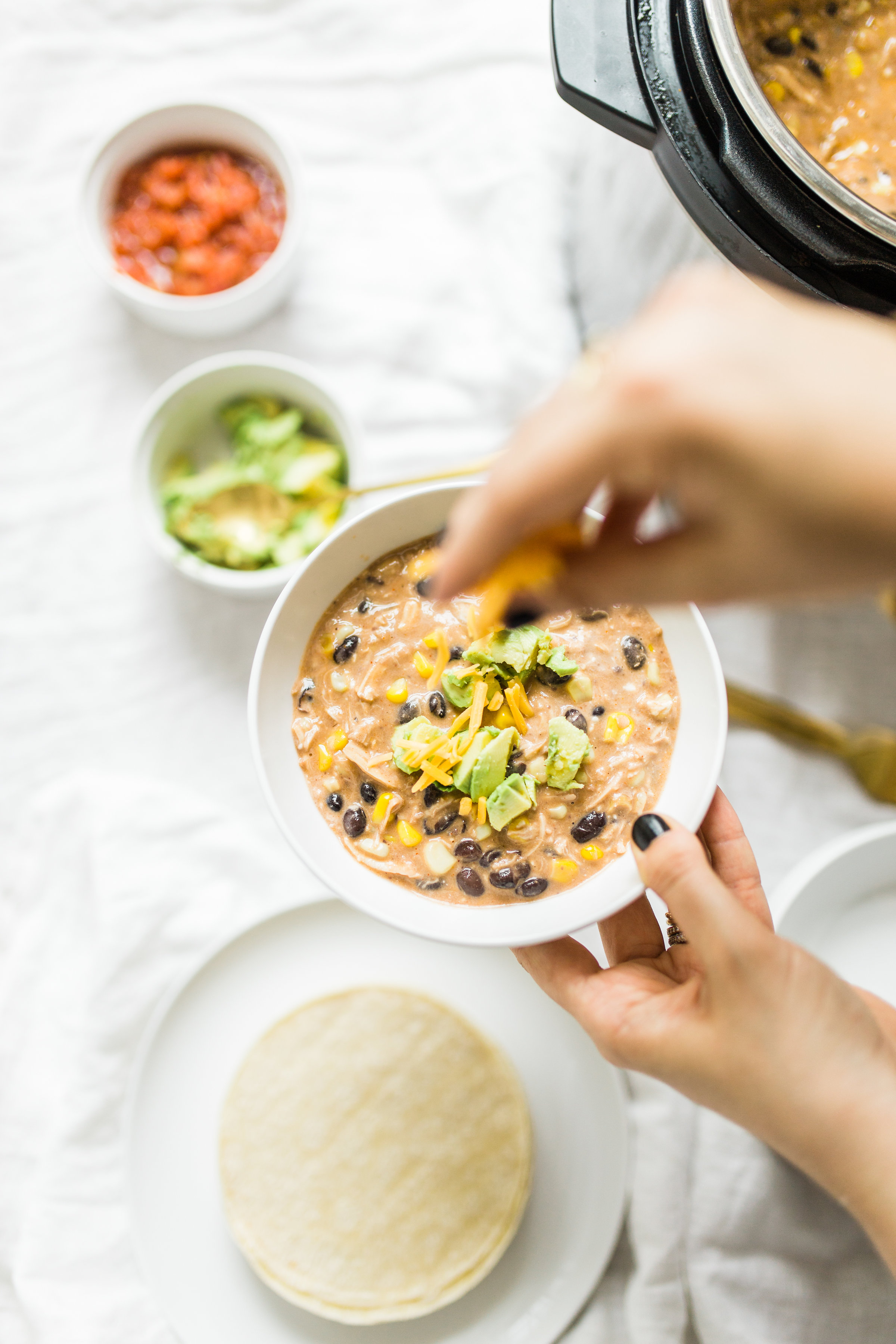 This easy and delicious creamy chicken enchilada soup is made in a crockpot or Instant Pot - a.k.a., dump it and forget it. Our whole family loves it. #crockpot #crockpotmeals #crockpotdinner #instantpot #instantpotdinner #instantpotchicken #crockpotchicken #chickenenchiladas #crockpotenchiladas #instantpotenchiladas #slowcooker #slowcookersoup #slowcookerenchiladas #slowcookermeals Click through for the recipe. | glitterinc.com | @glitterinc