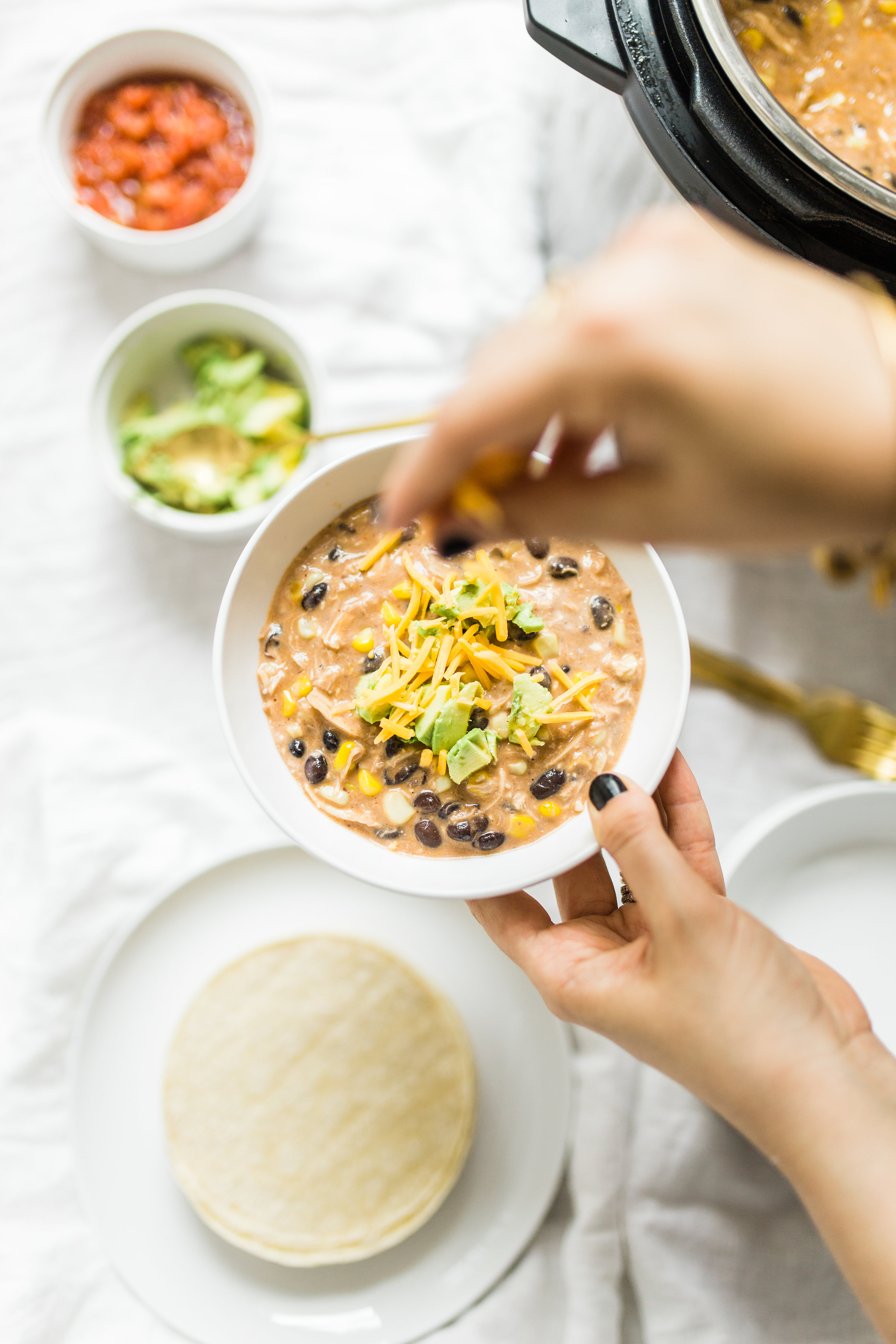 This easy and delicious creamy chicken enchilada soup is made in a crockpot or Instant Pot - a.k.a., dump it and forget it. Our whole family loves it. #crockpot #crockpotmeals #crockpotdinner #instantpot #instantpotdinner #instantpotchicken #crockpotchicken #chickenenchiladas #crockpotenchiladas #instantpotenchiladas #slowcooker #slowcookersoup #slowcookerenchiladas #slowcookermeals Click through for the recipe. | glitterinc.com | @glitterinc