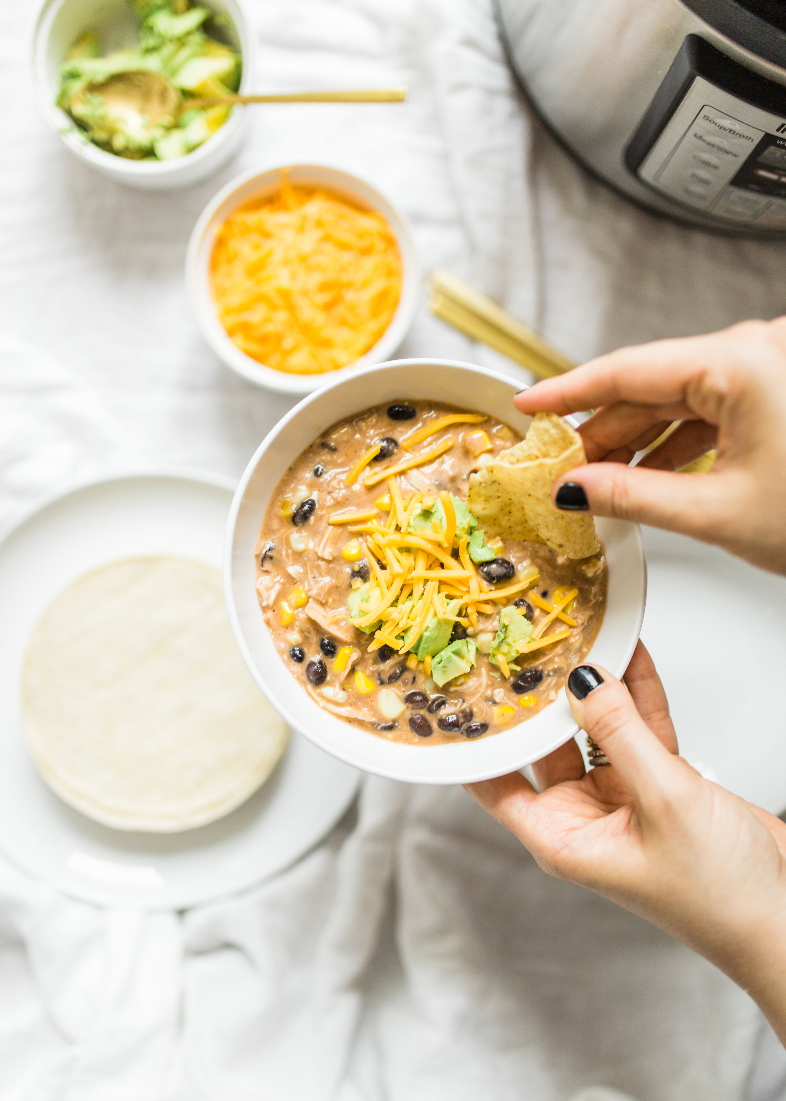 This easy and delicious creamy chicken enchilada soup is made in a crockpot or Instant Pot - a.k.a., dump it and forget it. Our whole family loves it. #crockpot #crockpotmeals #crockpotdinner #instantpot #instantpotdinner #instantpotchicken #crockpotchicken #chickenenchiladas #crockpotenchiladas #instantpotenchiladas #slowcooker #slowcookersoup #slowcookerenchiladas #slowcookermeals Click through for the recipe. | glitterinc.com | @glitterinc